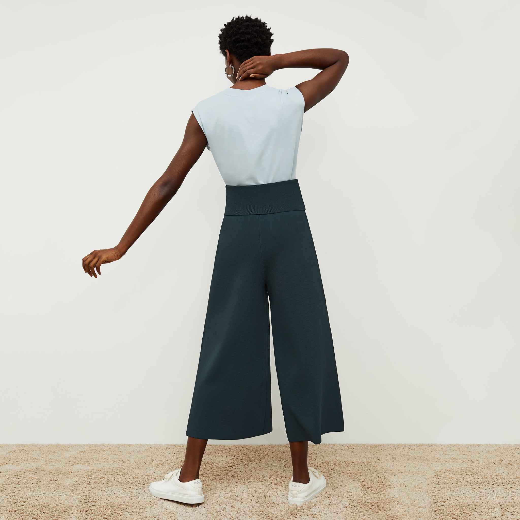 Back image of a woman standing wearing the Alina T-Shirt—Compact Cotton in Sky Blue