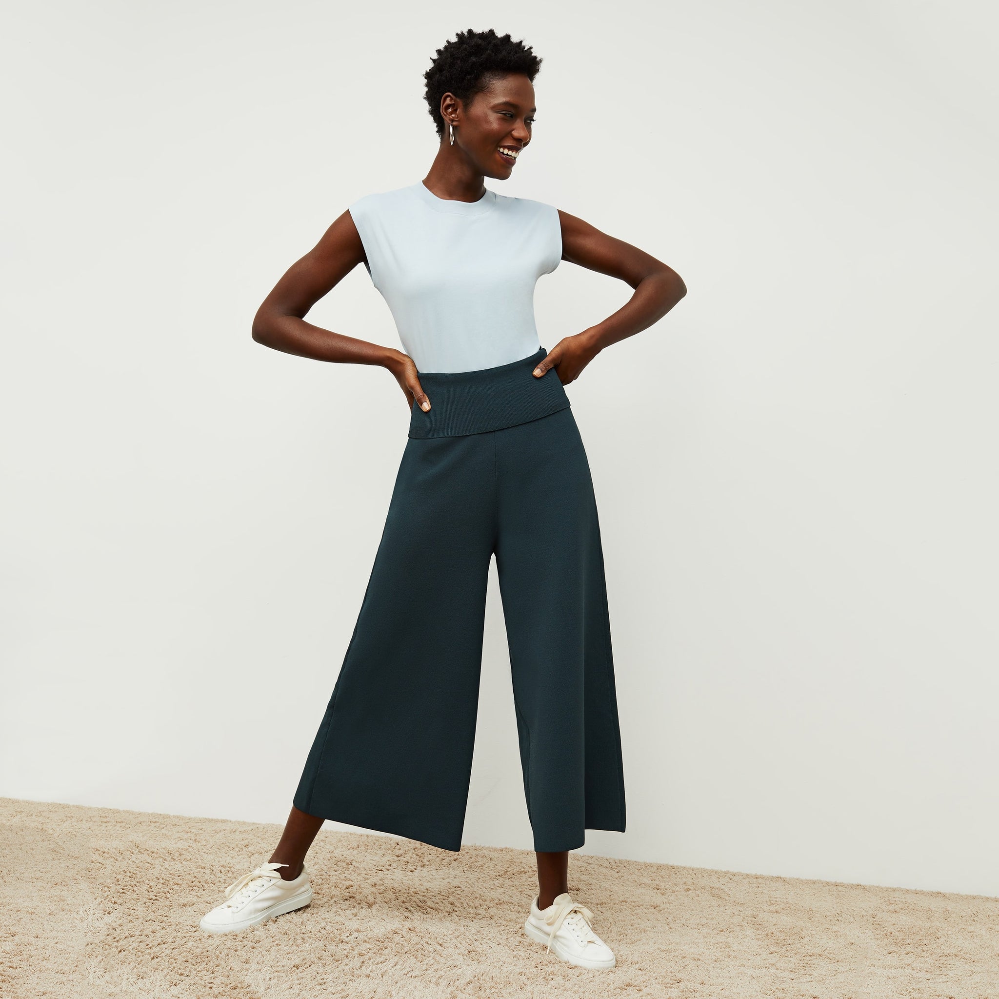 Front image of a woman standing wearing the Alina T-Shirt—Compact Cotton in Sky Blue 