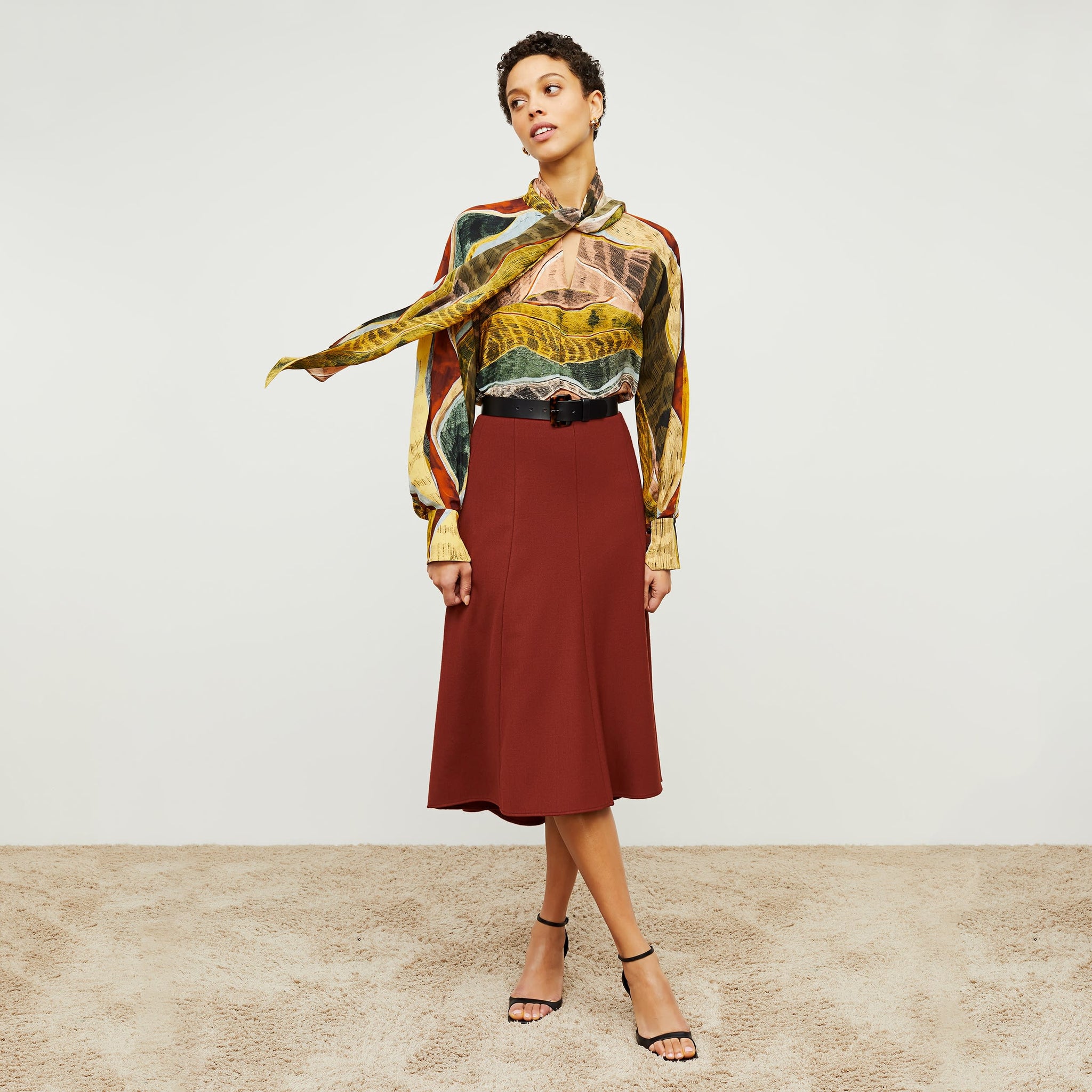 Front image of a woman standing wearing the Fiona Top—Silk Desert in Multicolor