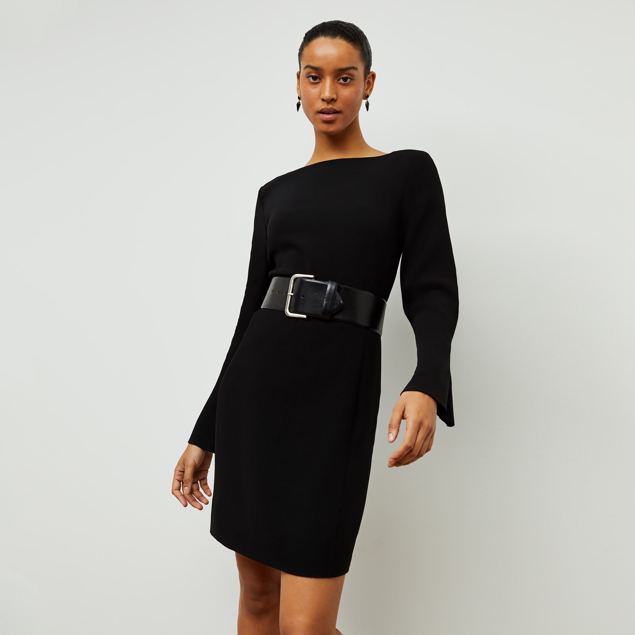 Front image of a woman standing wearing the Regina Dress in Black 