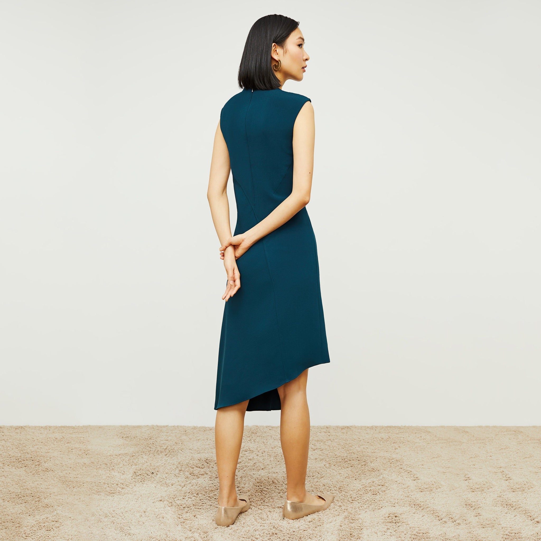 Back image of a woman standing wearing the Lara Dress in Rainforest