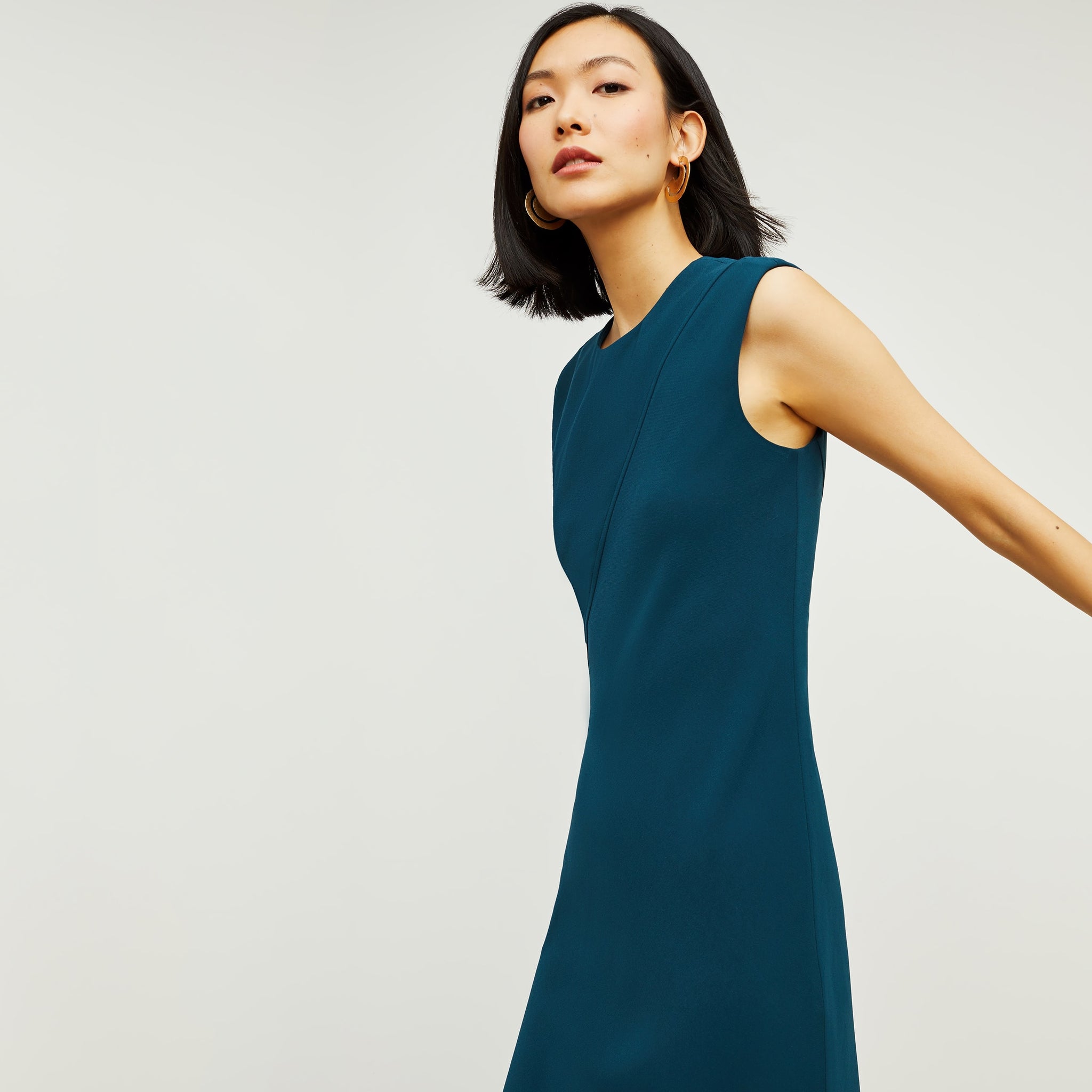 Side image of a woman standing wearing the Lara Dress in Rainforest