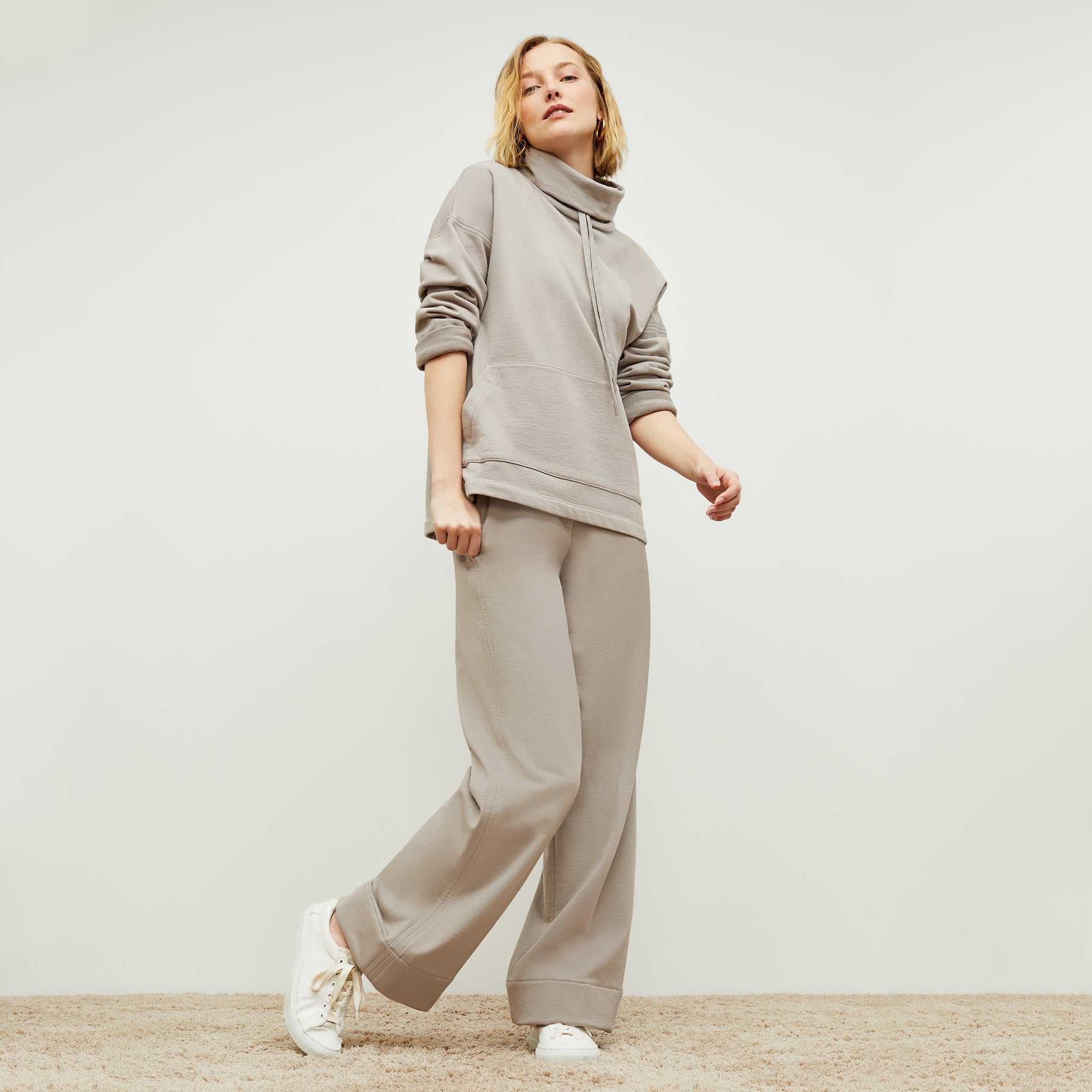 Front image of a woman standing wearing the Georgina Lounger—Fine Terry in Smoky Taupe