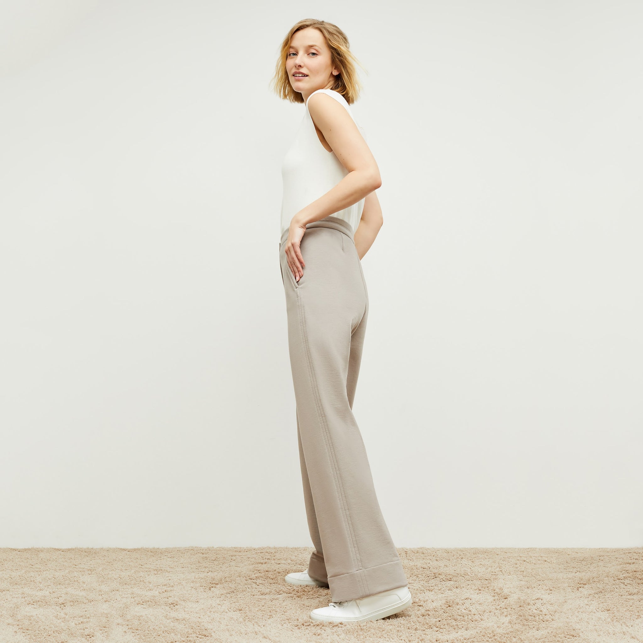 Side image of a woman standing wearing the Georgina Lounger—Fine Terry in Smoky Taupe 