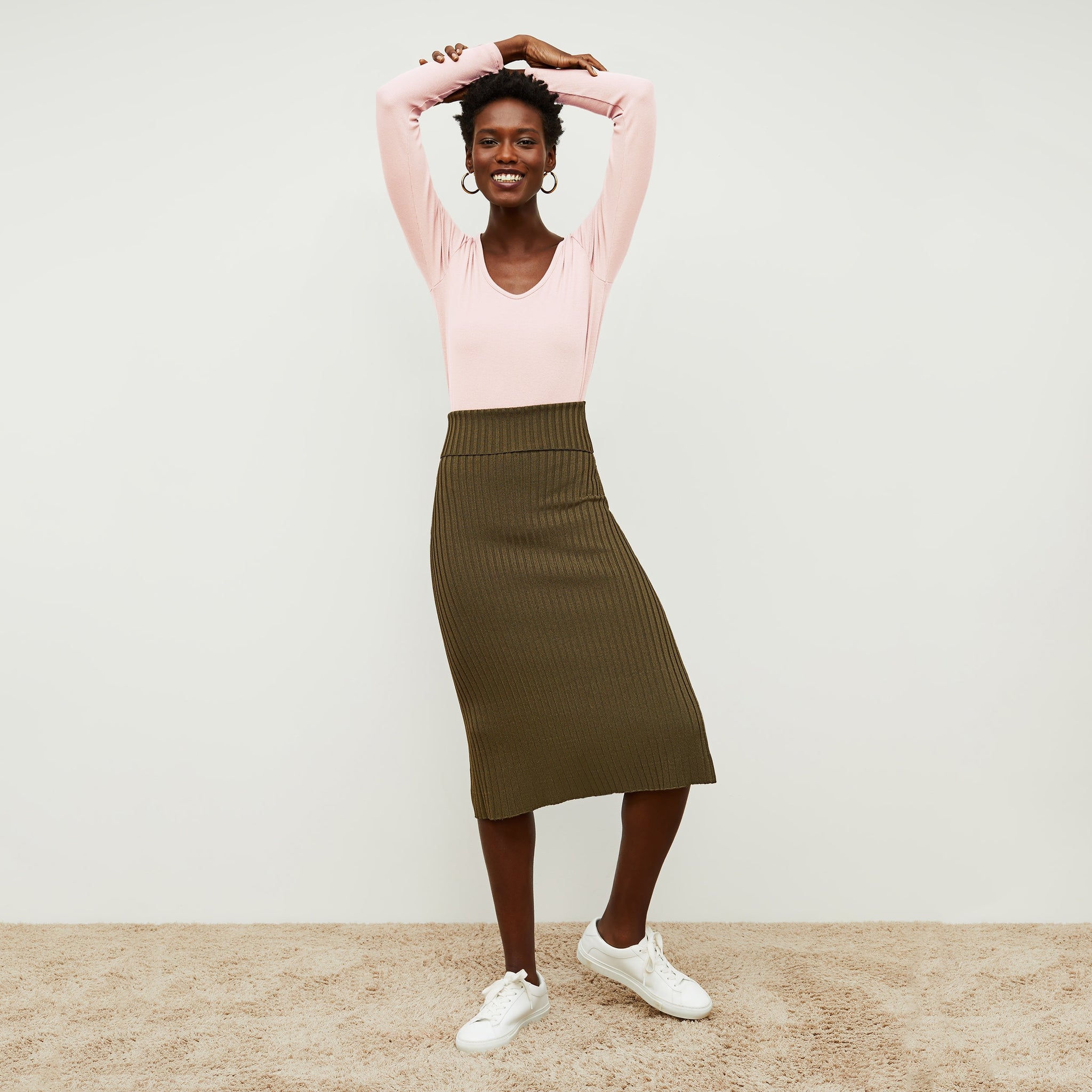 Front image of a woman standing wearing the York skirt in Safari