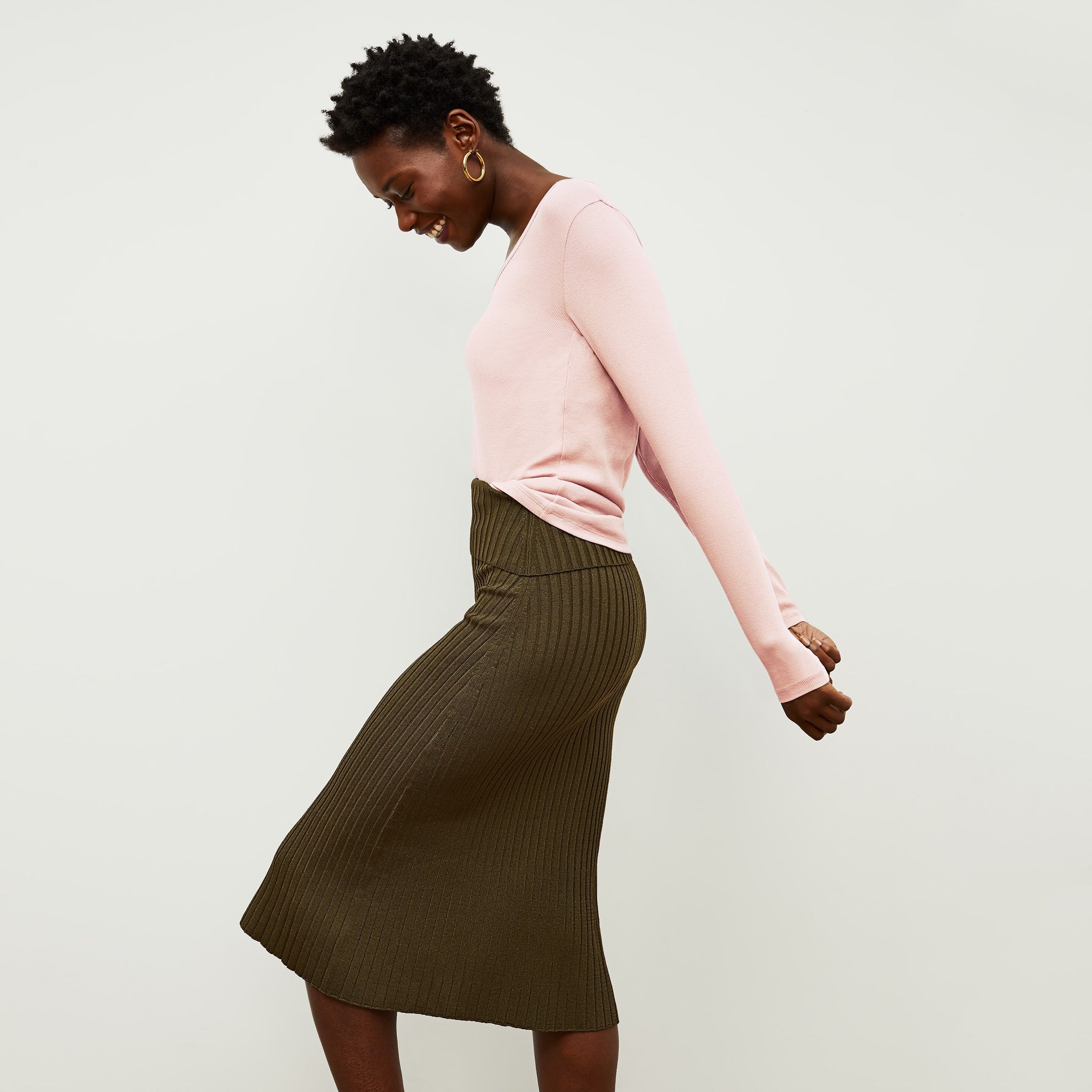 Side image of a woman standing wearing the York Skirt in Safari