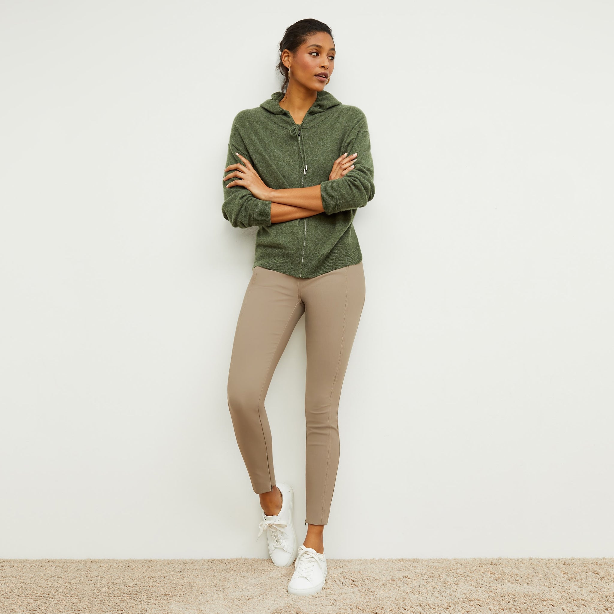 Front image of a woman standing wearing the Judith Hoodie—Cashmere in Olive