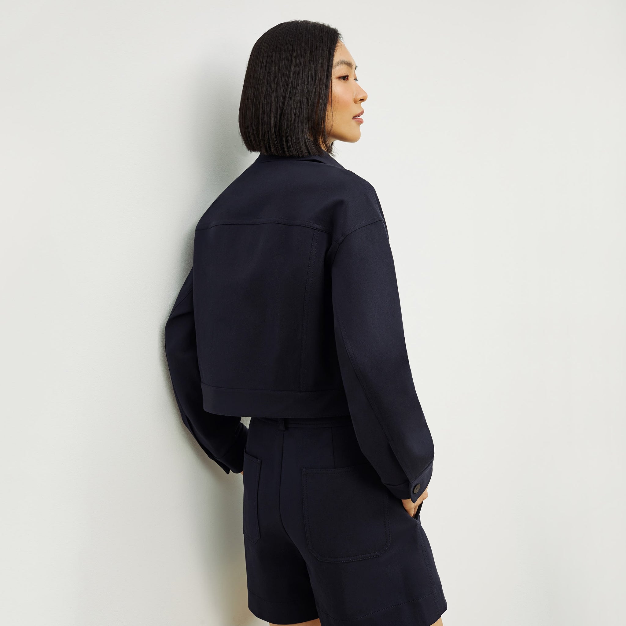Back image of a woman standing wearing the Anna Jacket—Better Than Denim in Ink