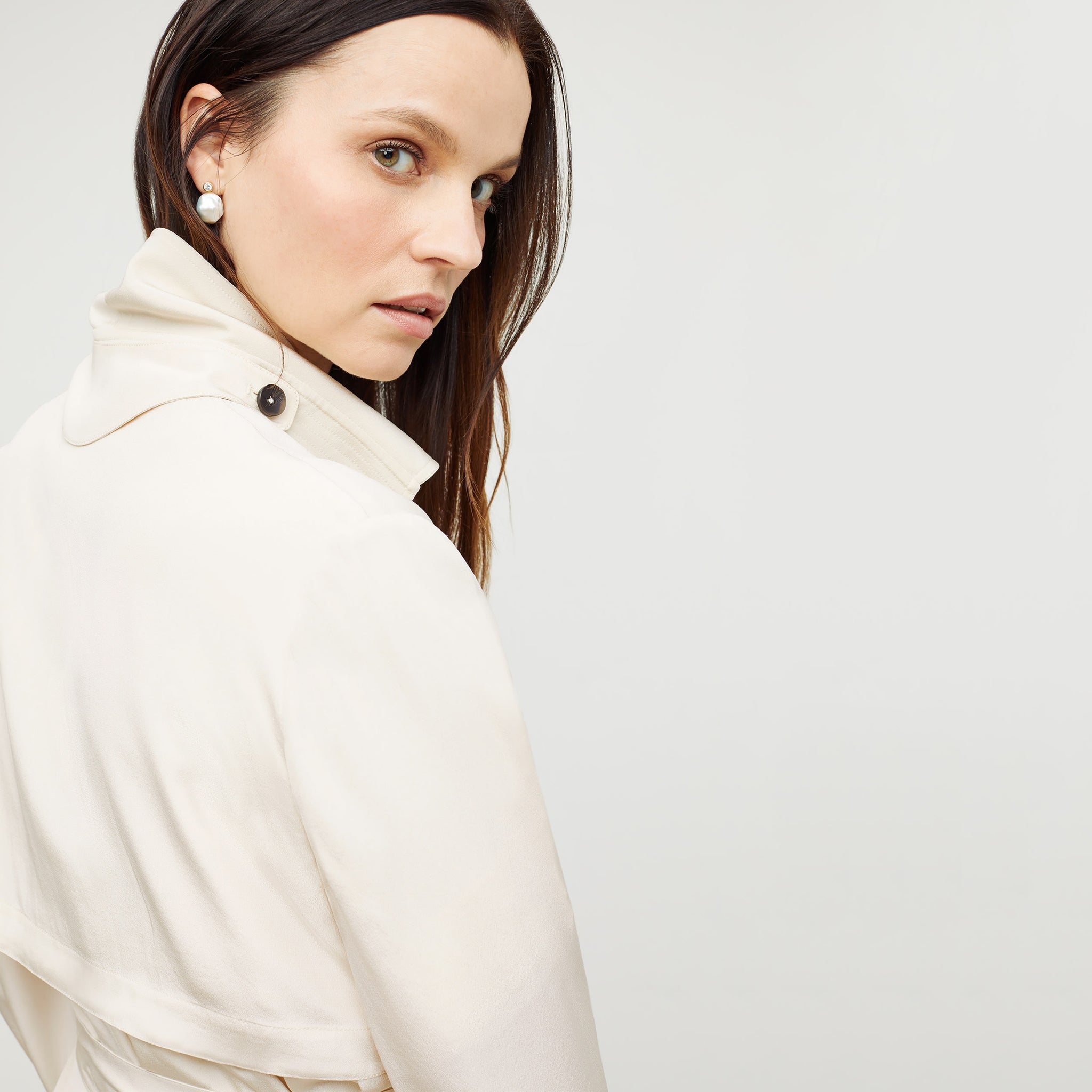 Detail image of a woman standing wearing the Jensen Trench—SustainSilk in Pearl