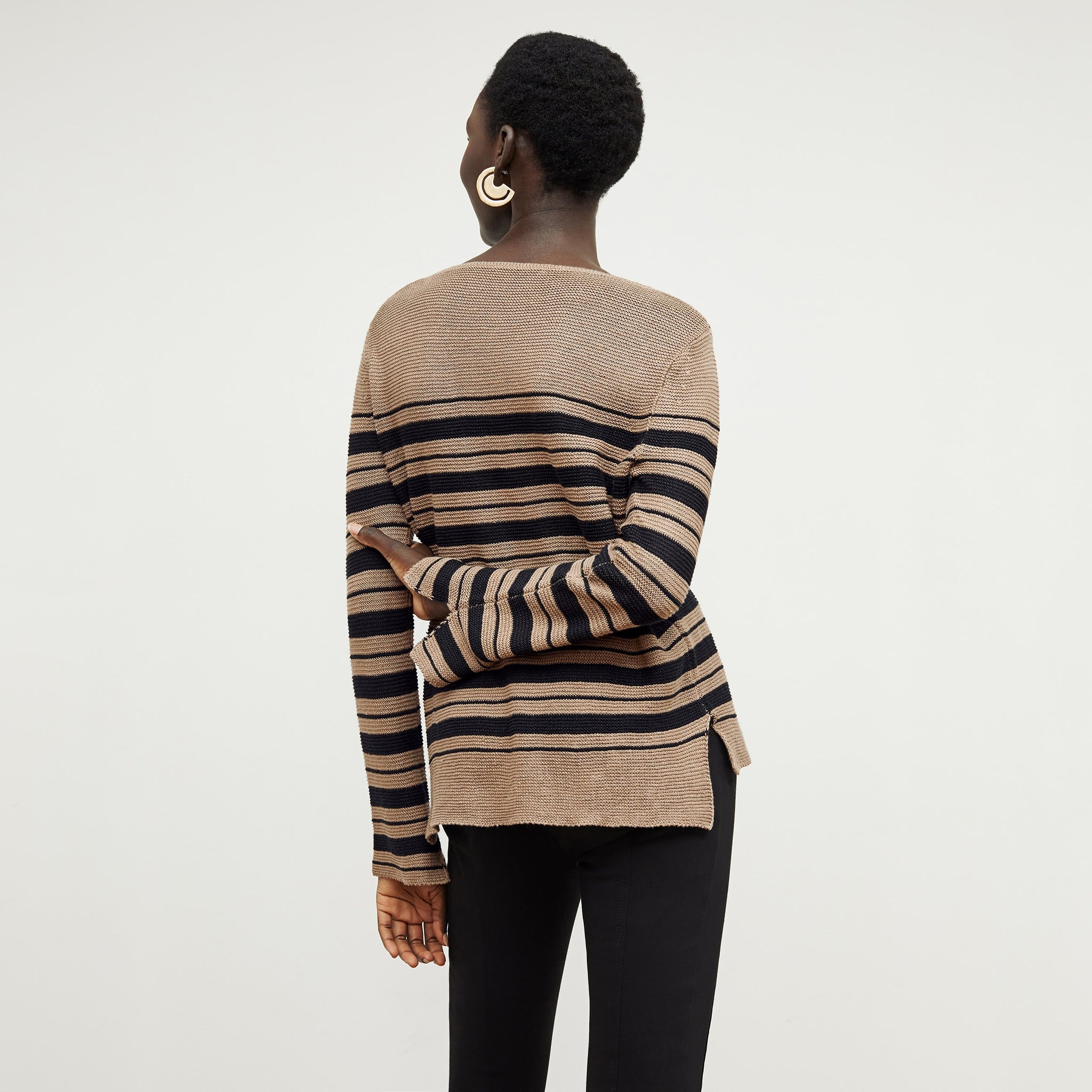 Back image of a woman standing wearing the Samara Sweater—Knit Linen in Oak / Black