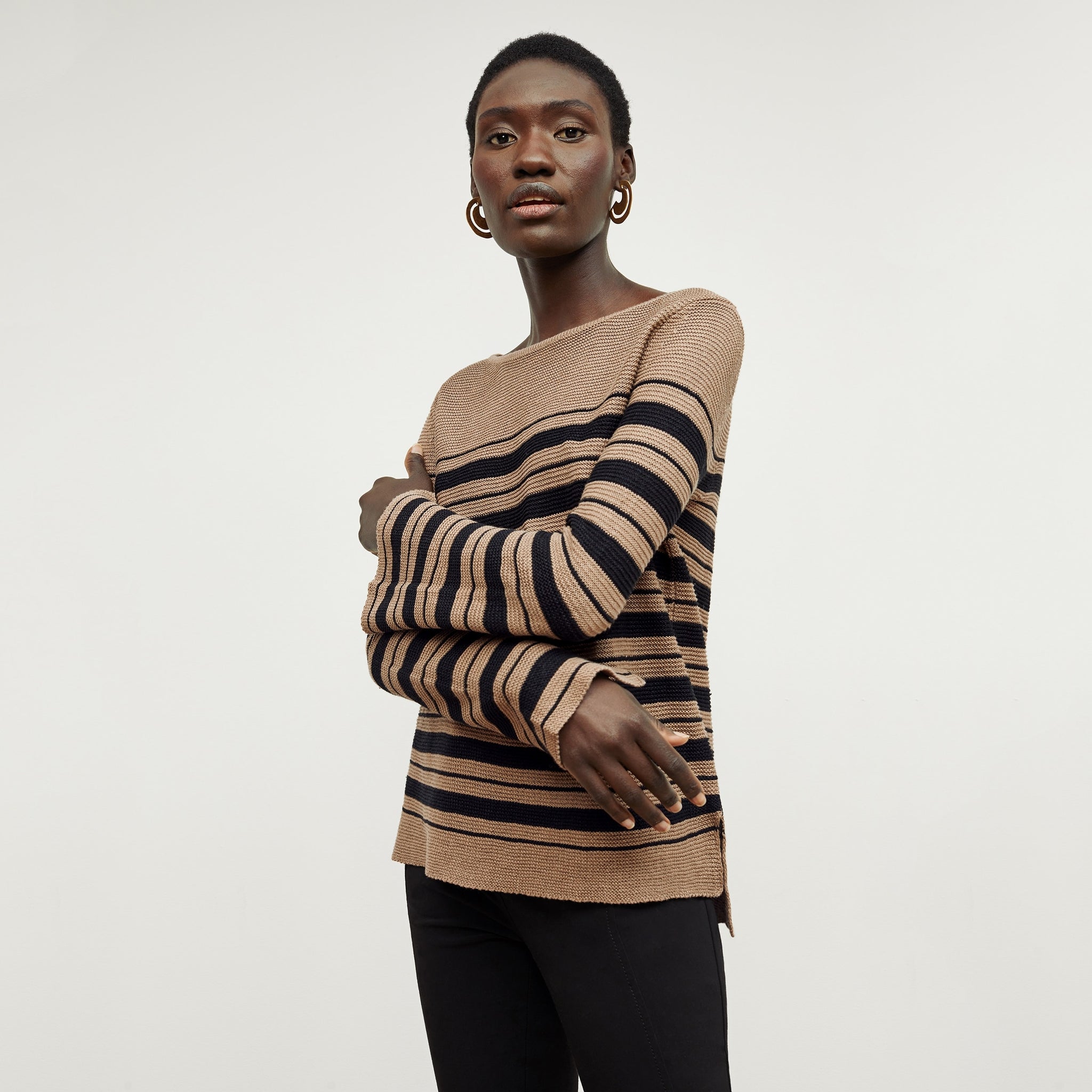Front image of a woman standing wearing the Samara Sweater—Knit Linen in Oak / Black