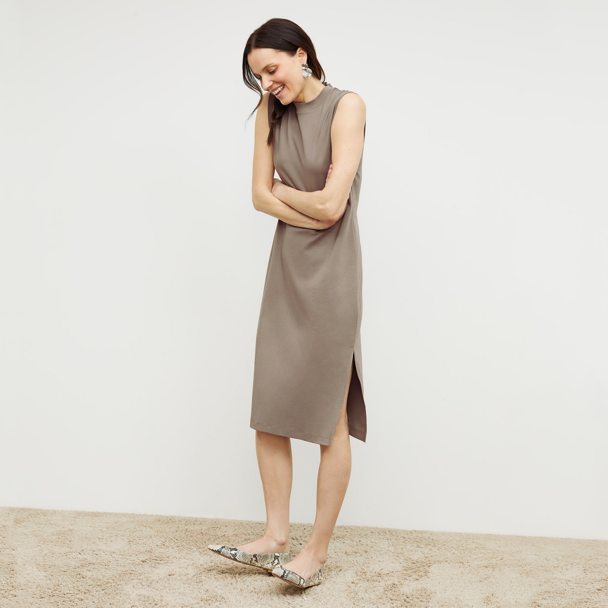 Front image of a woman standing wearing the Lou Dress—Compact Cotton in Pebble