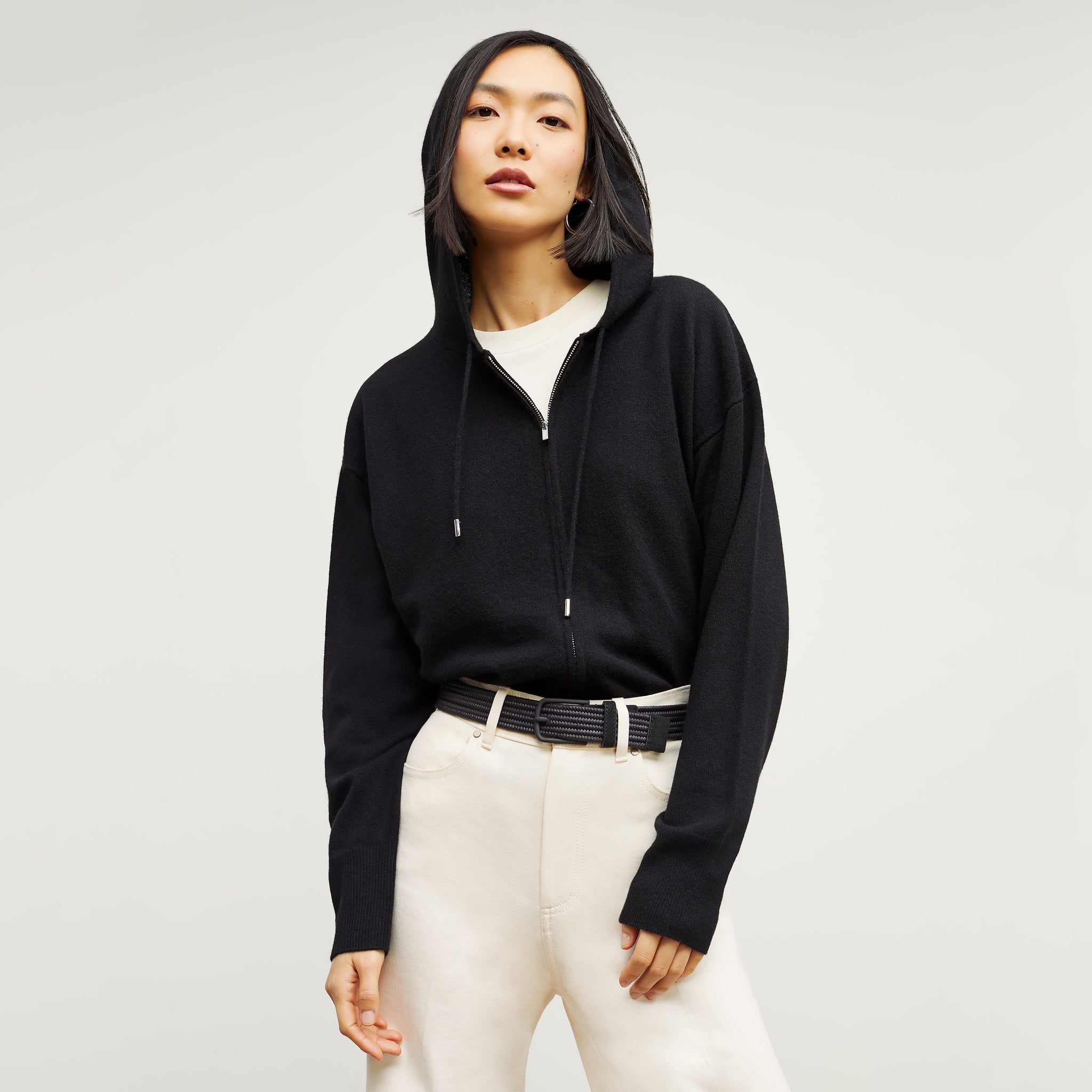 Front image of a woman standing wearing the Judith Hoodie—Cashmere in Black