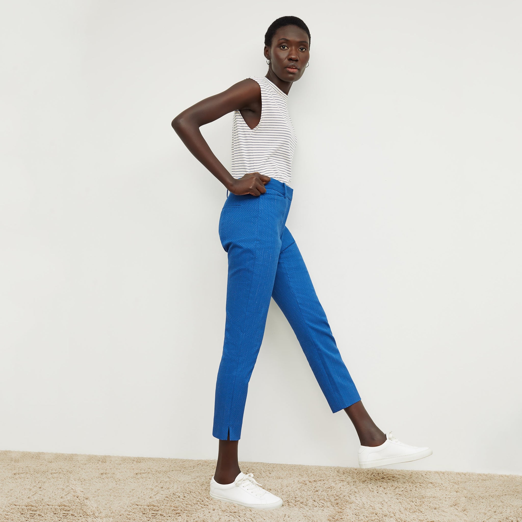 Side image of a woman standing wearing the condesa pant in basketweave jacquard in azure