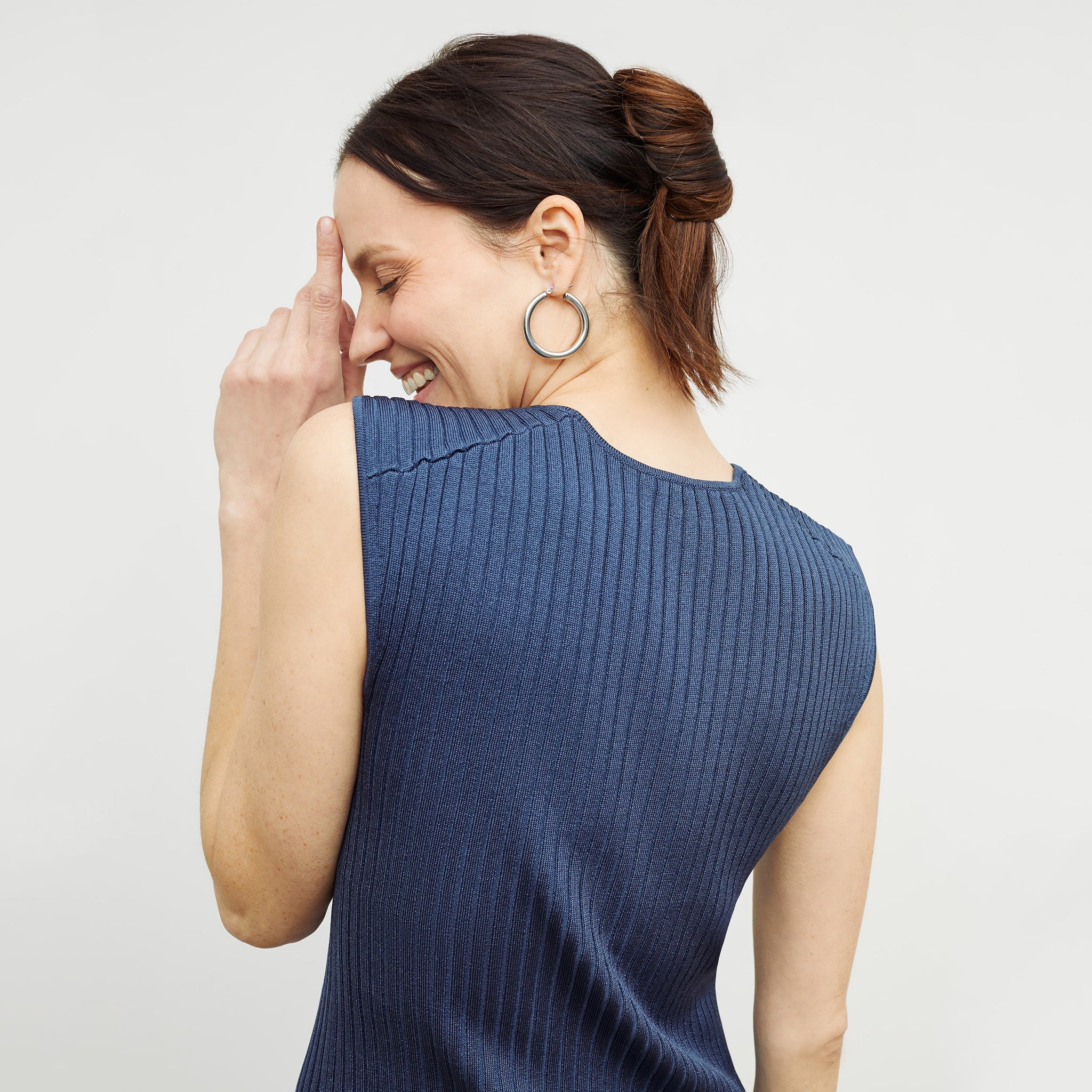 Back image of a woman standing wearing the dylan dress in adriatic blue