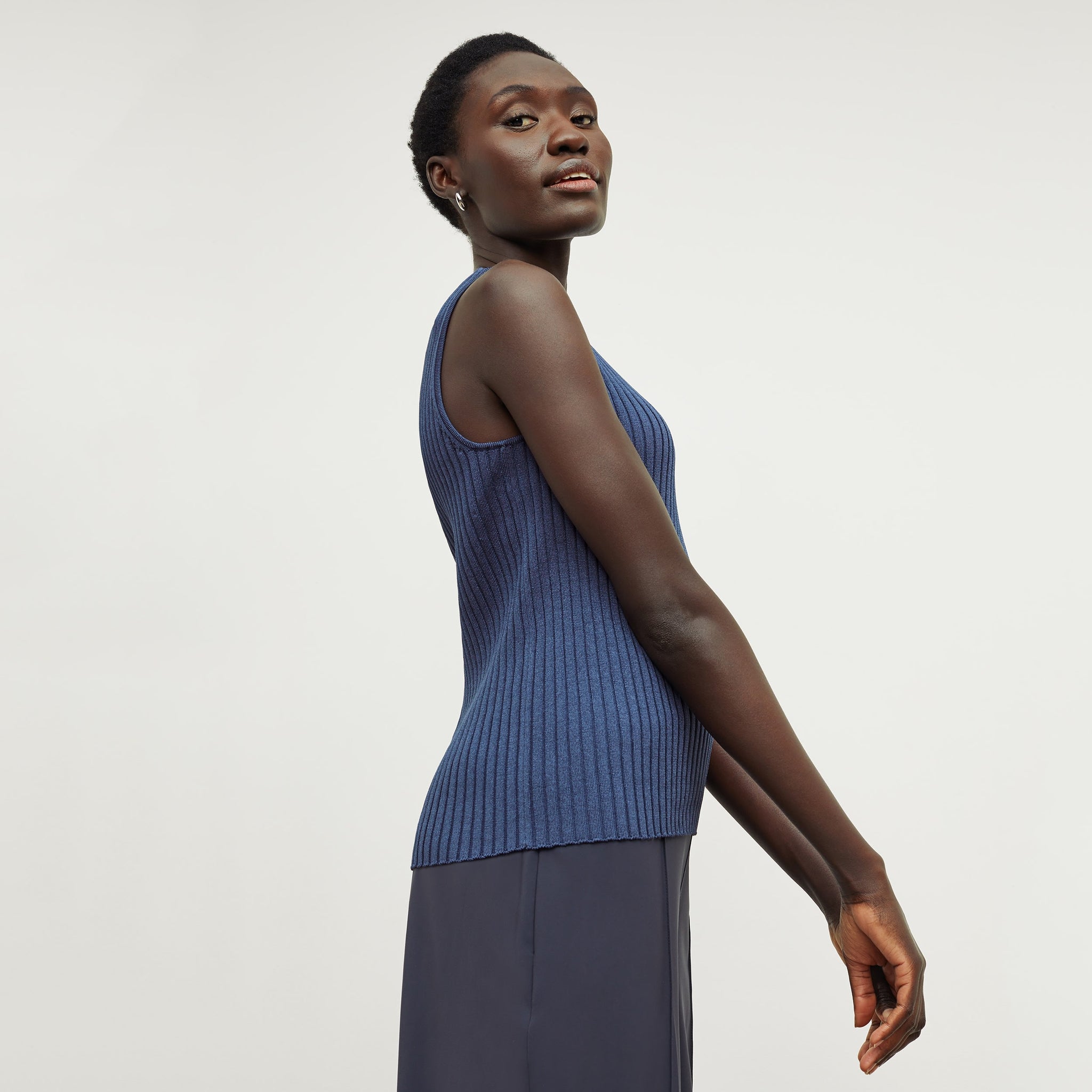 Side image of a woman standing wearing the avery top in adriatic blue