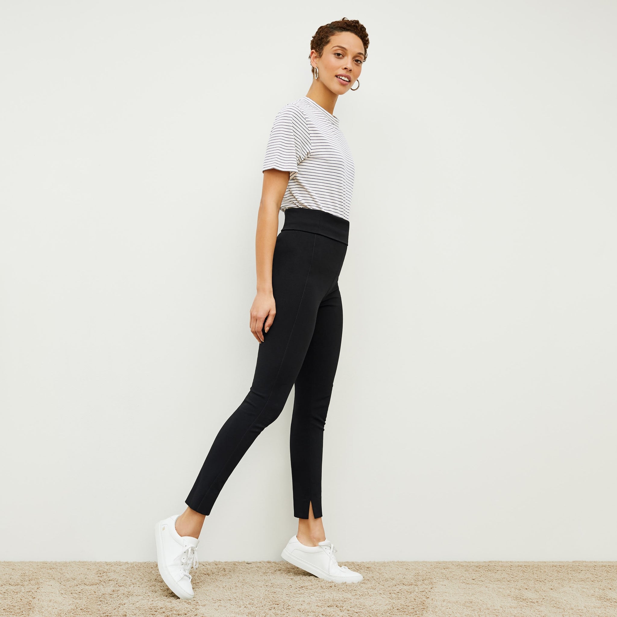 Side image of a woman standing wearing the stella legging in black 