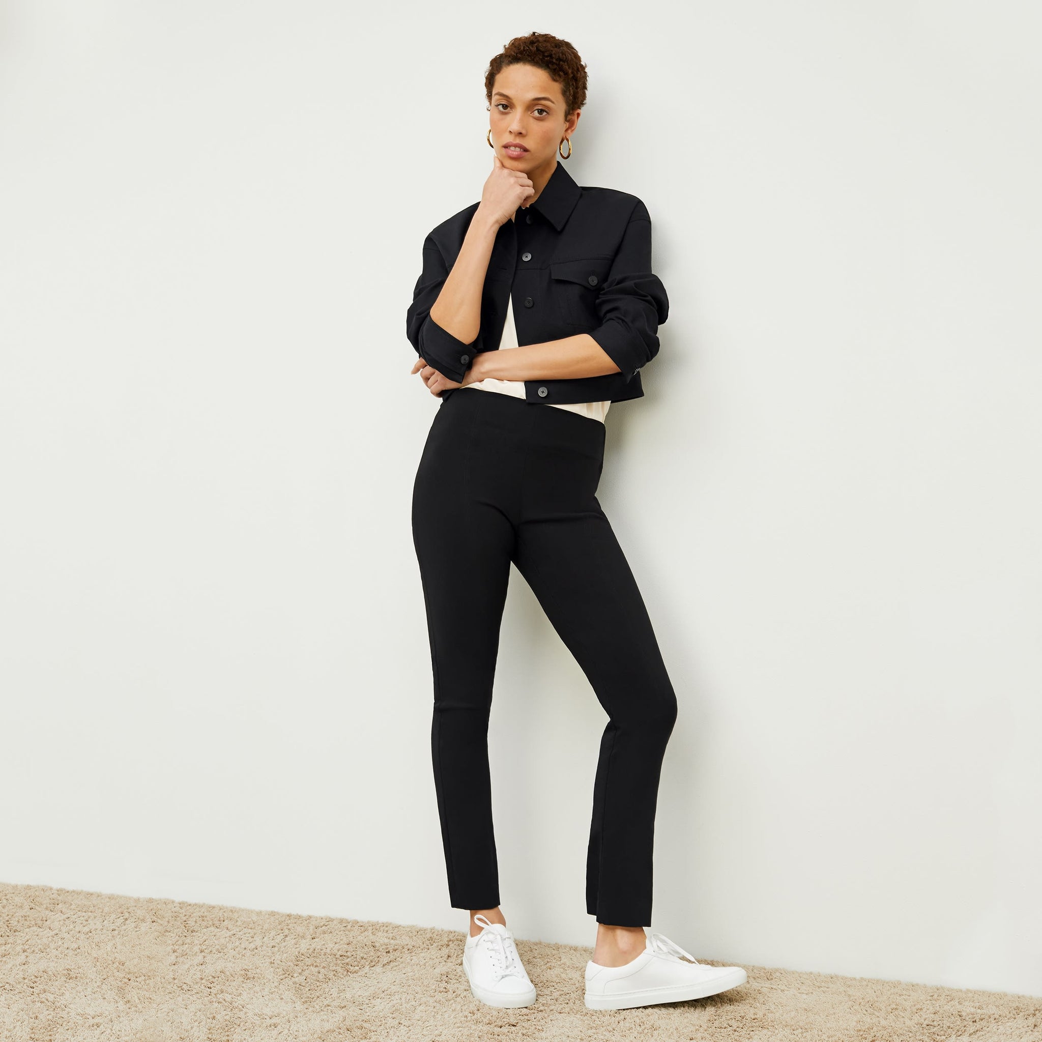 Front image of a woman standing wearing the Foster Pant—Everstretch in Black