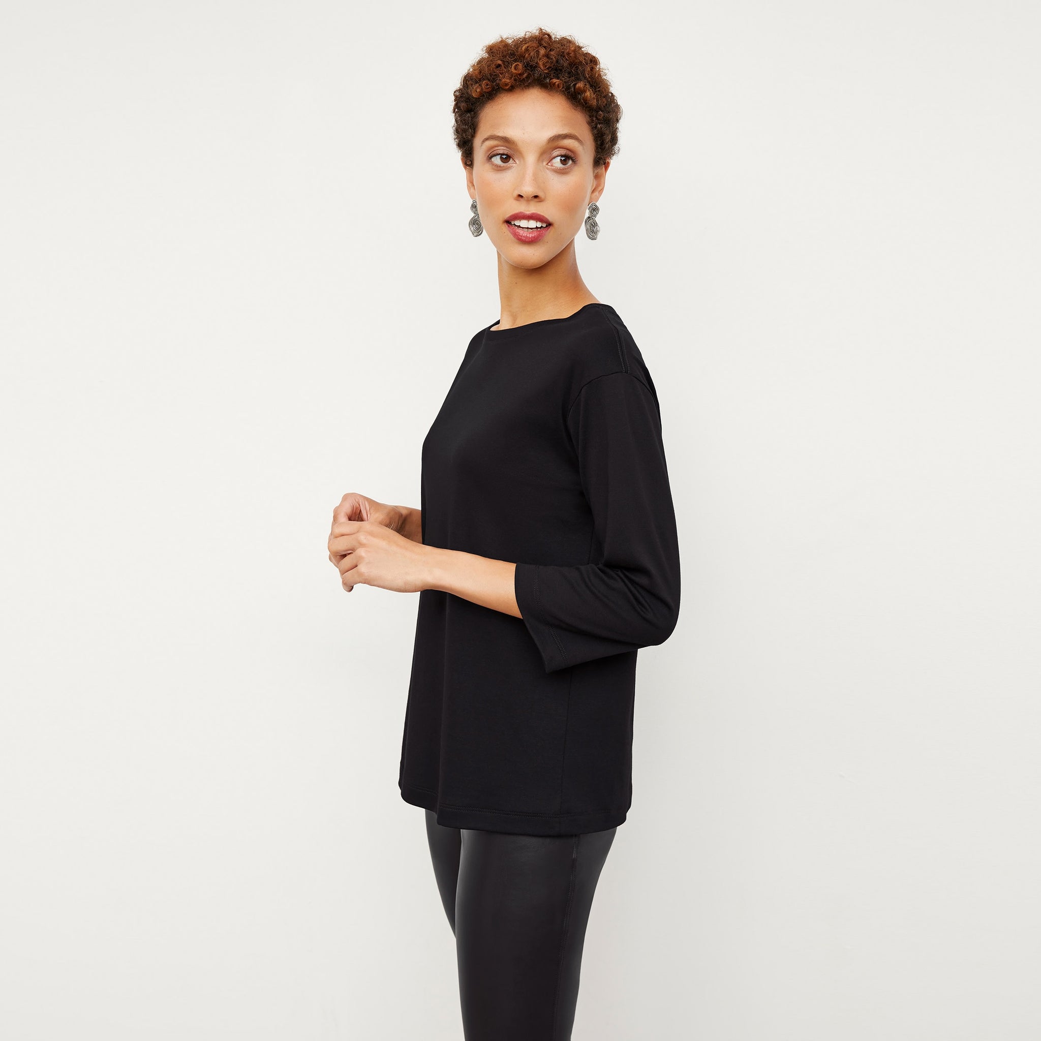 Side image of a woman wearing the Owen T-Shirt in Black