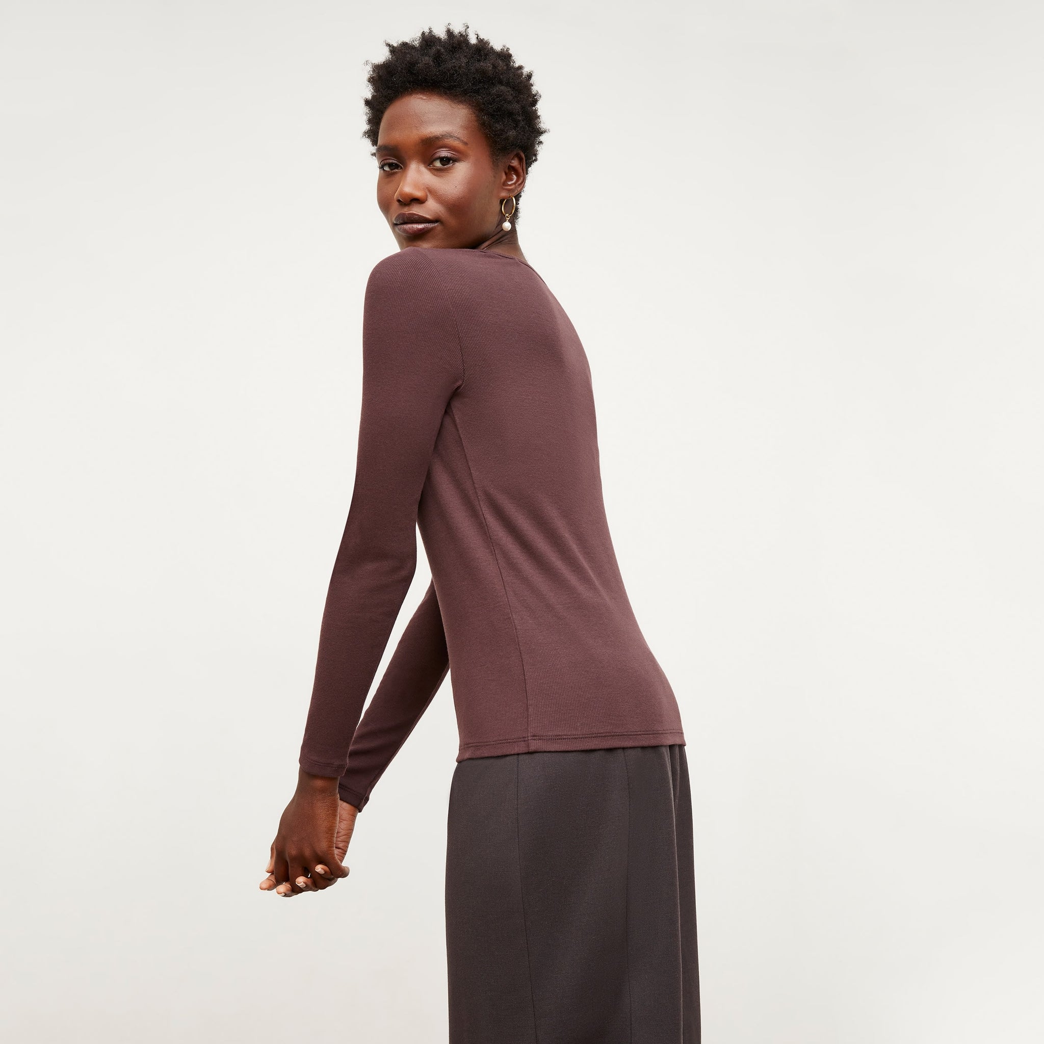 Side image of a woman standing wearing the Marcia T-Shirt--Ribbed Pima Cotton in Huckleberry