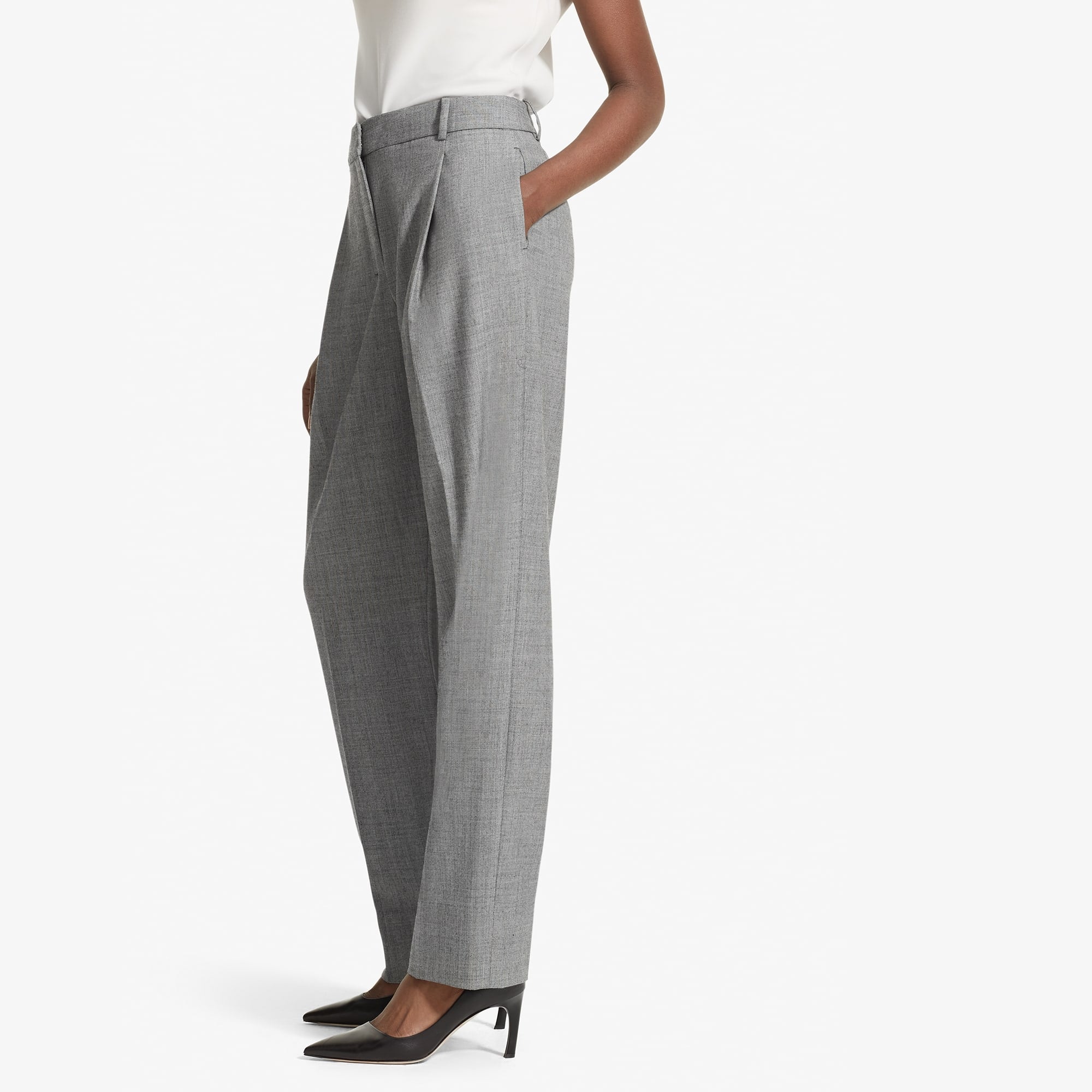 Side image of a woman standing wearing the elliott trouser--sharkskin in black and white