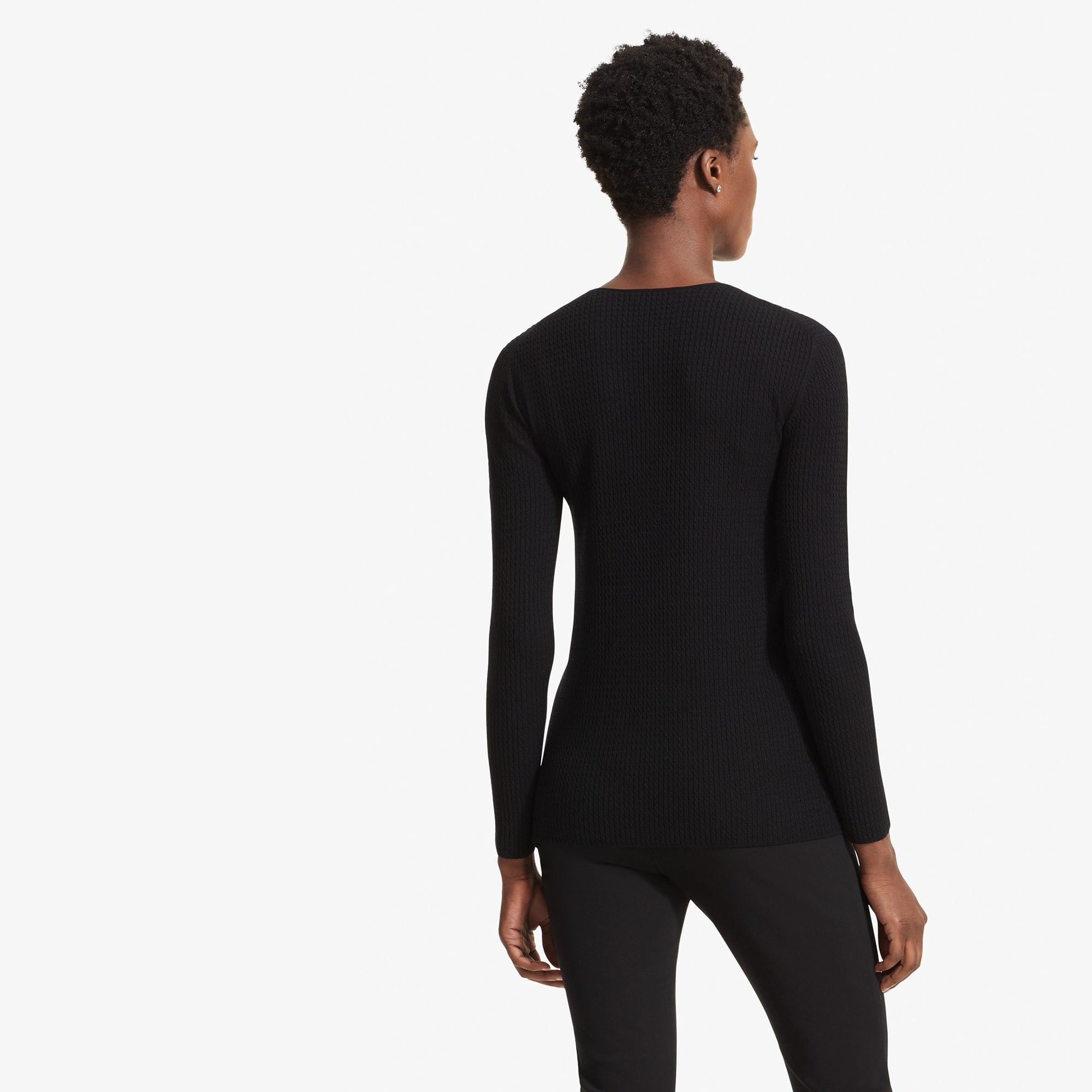 Back image of a woman standing wearing the Loraine top in Black