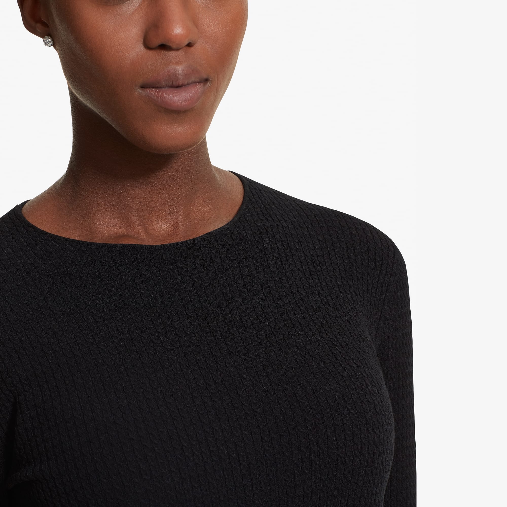 Detail image of a woman standing wearing the Loraine top in Black