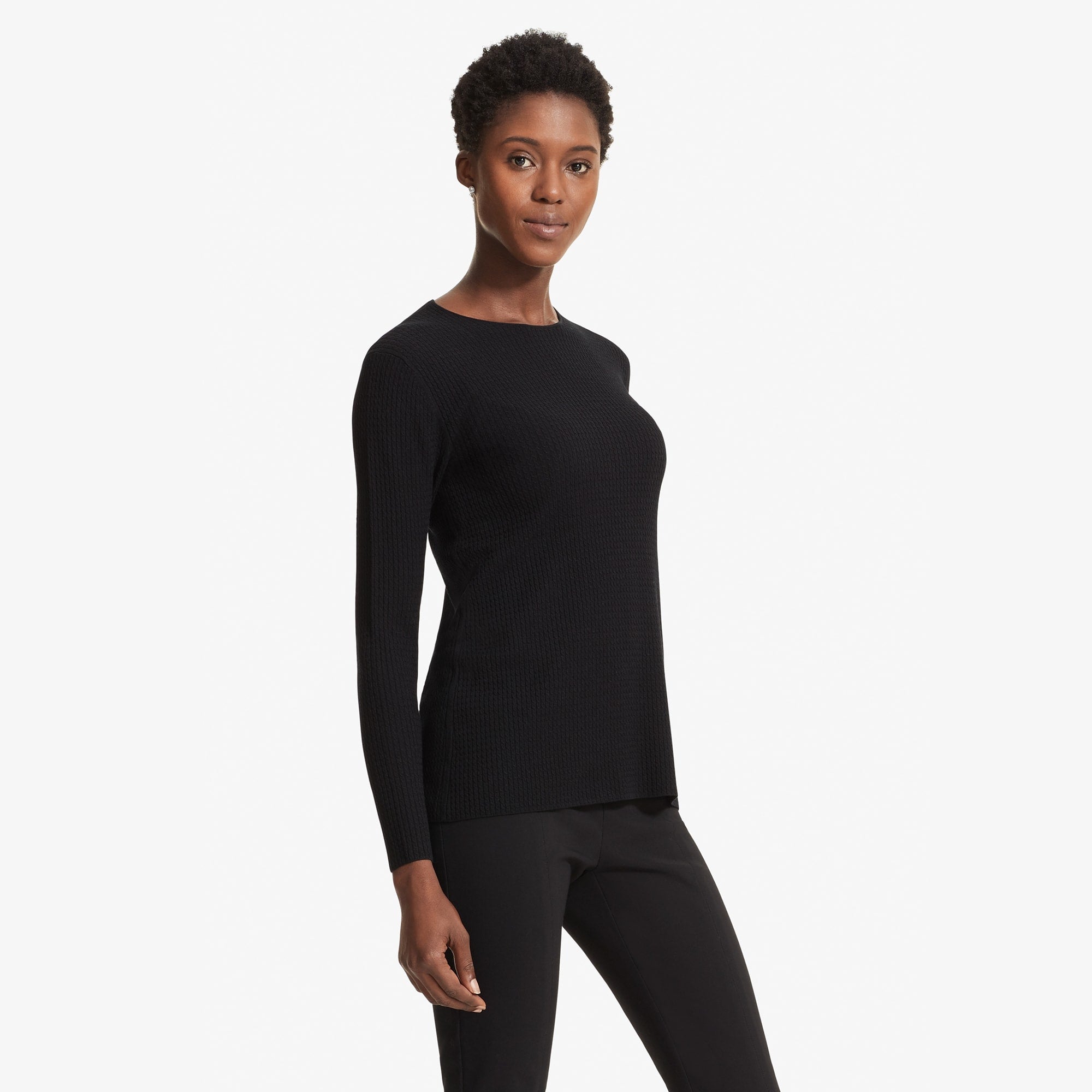 Side image of a woman standing wearing the Loraine top in Black