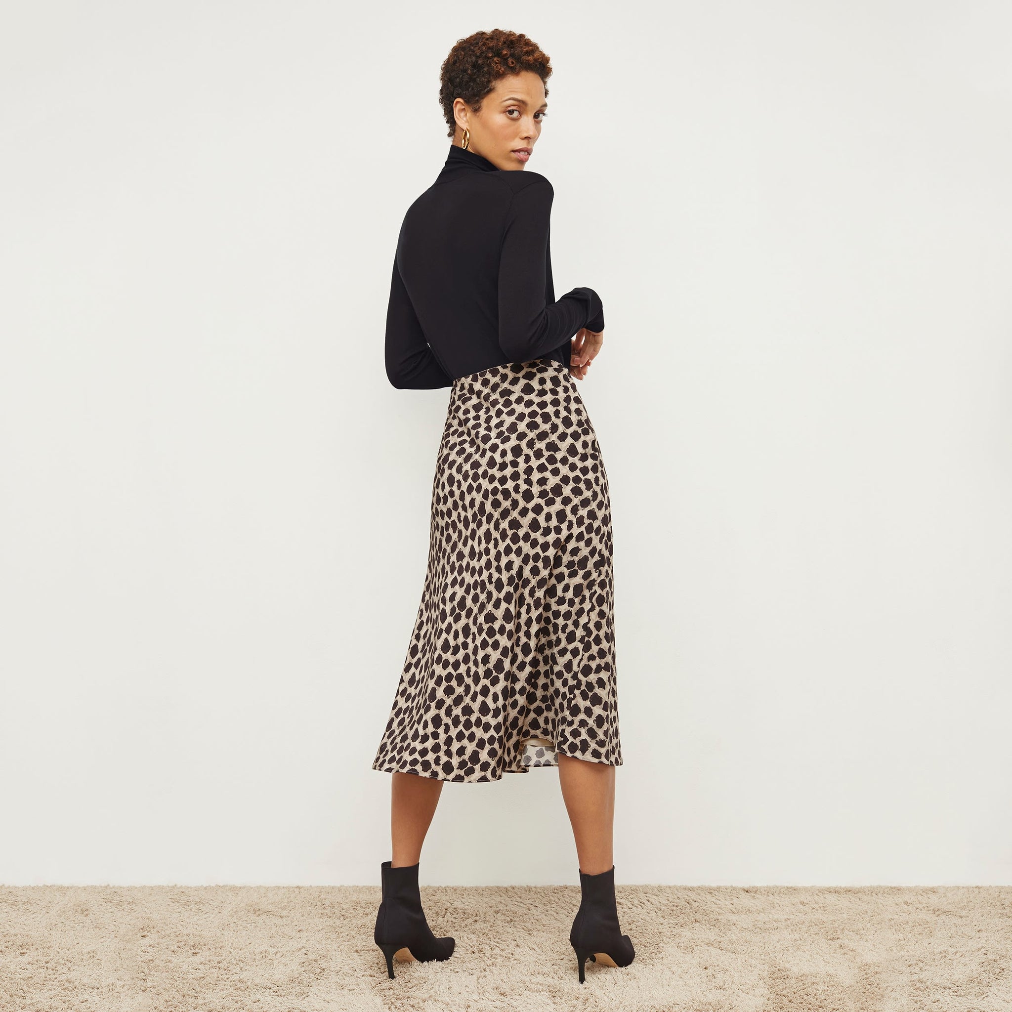Back image of a woman wearing the orchard skirt in sahara print