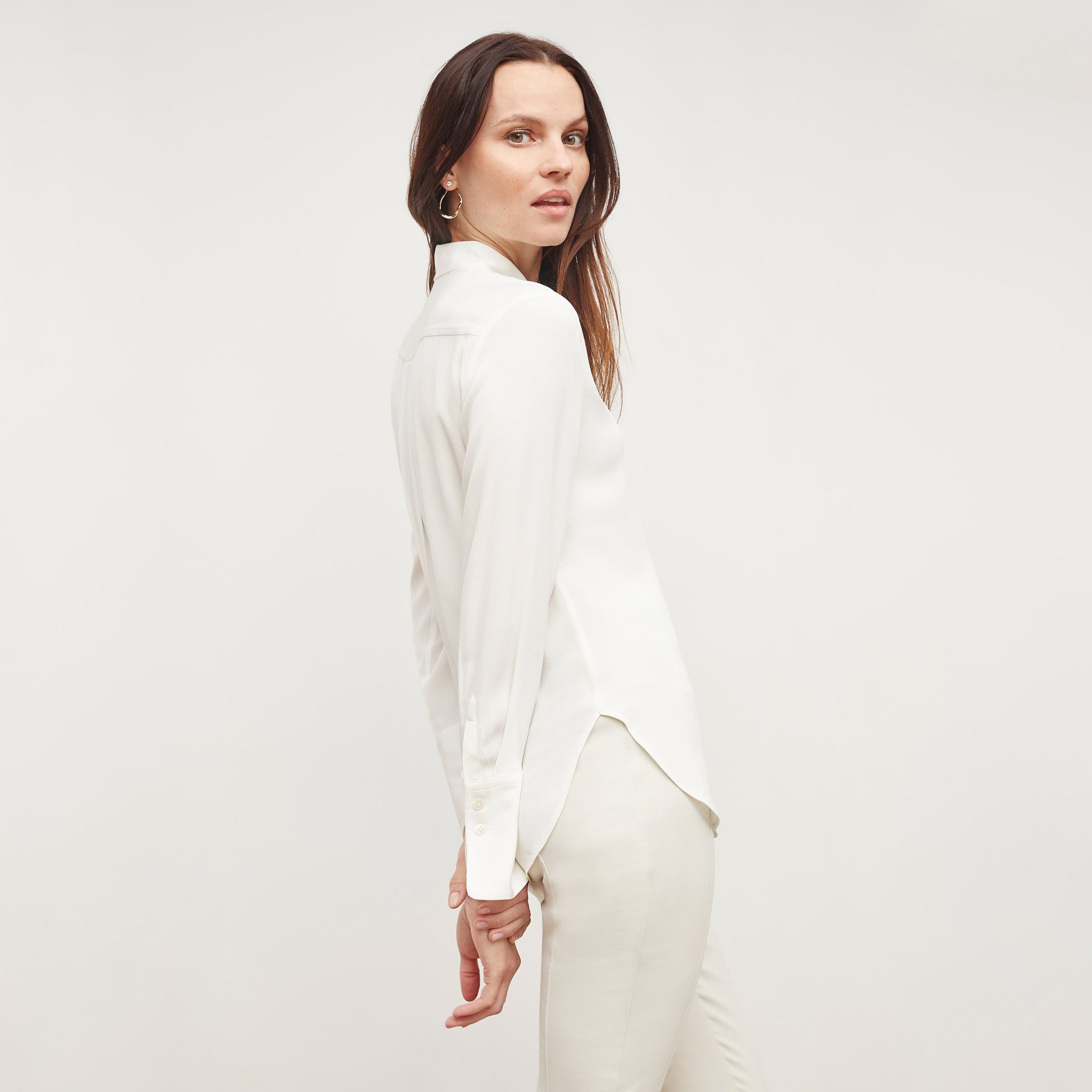 Front image of a woman wearing the tatum shirt in ivory