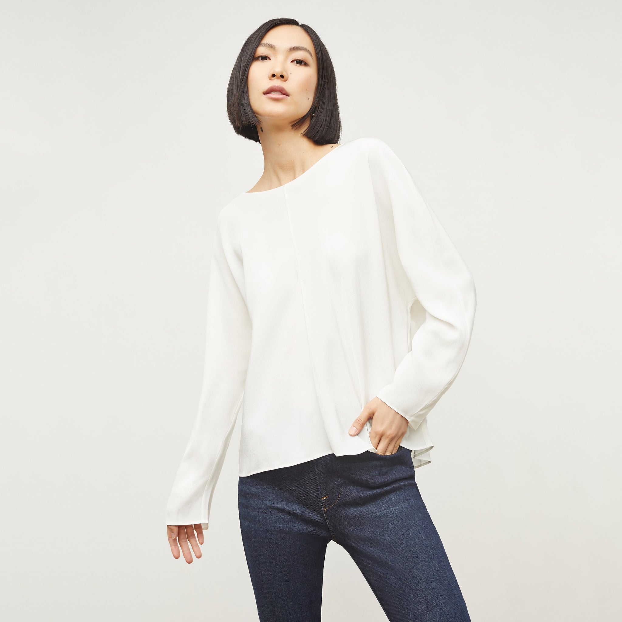 Image of a woman wearing the Wren top in ivory