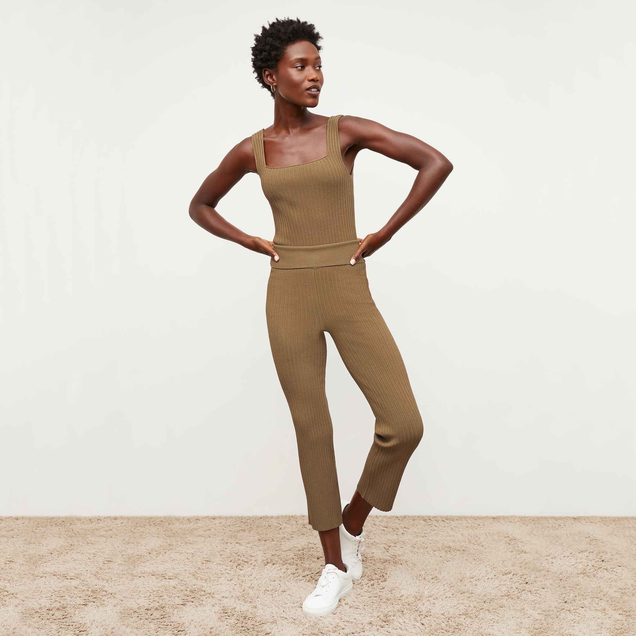 Front image of a woman standing wearing the Finley Legging—Ribbed Jardigan Knit in Light Bronze 