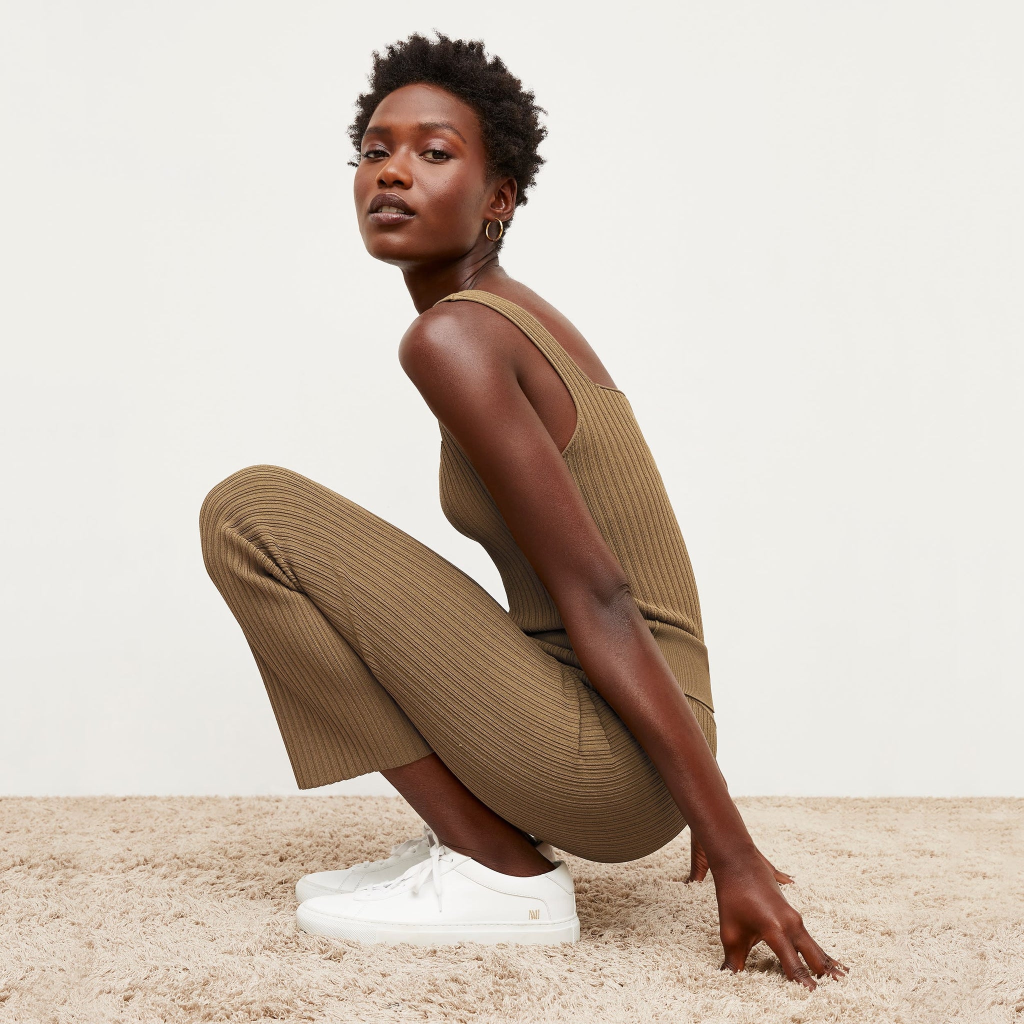 Side image of a woman standing wearing the Finley Legging—Ribbed Jardigan Knit in Light Bronze