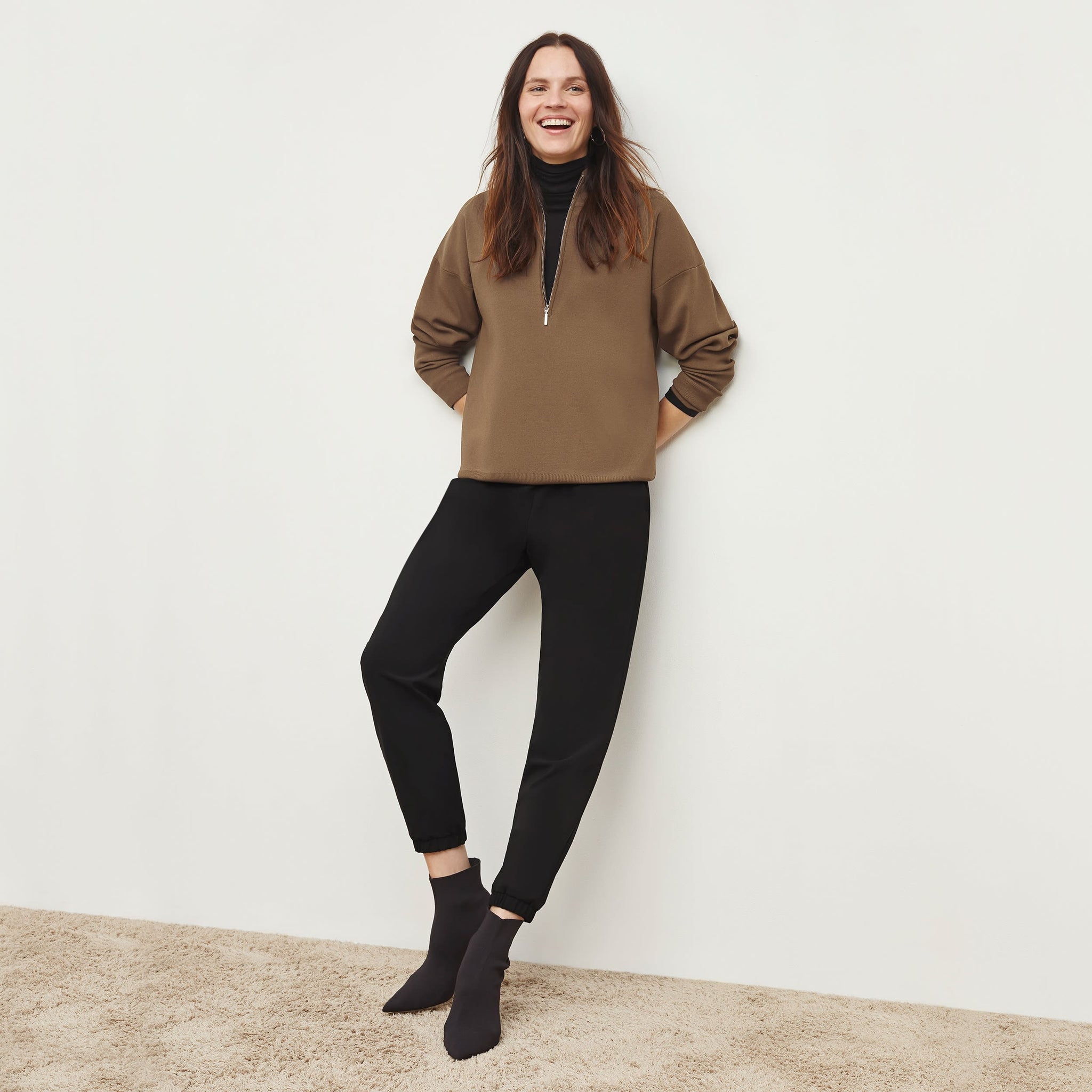 Front image of a woman standing wearing the Athens Half Zip—Jardigan Knit in Light Bronze