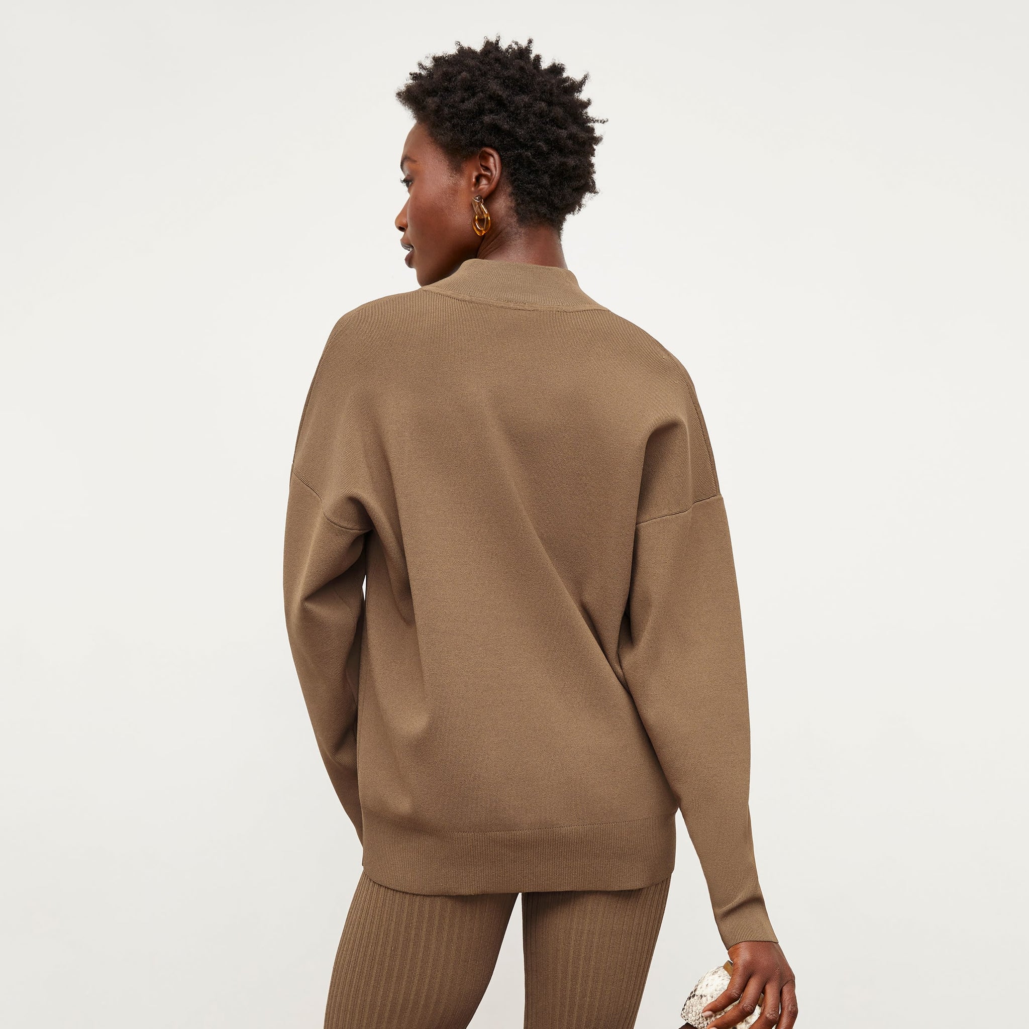 Back image of a woman standing wearing the Athens Half Zip—Jardigan Knit in Light Bronze