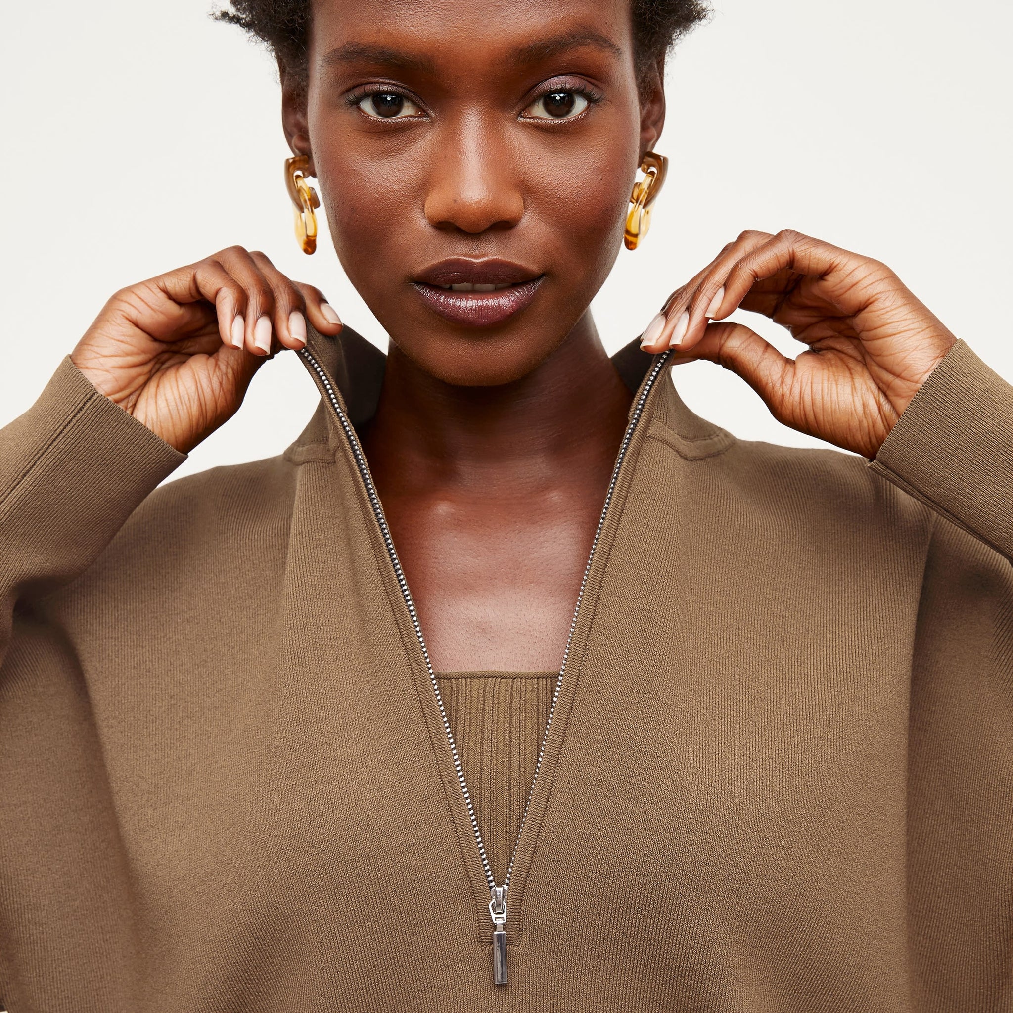 Detail image of a woman standing wearing the Athens Half Zip—Jardigan Knit in Light Bronze
