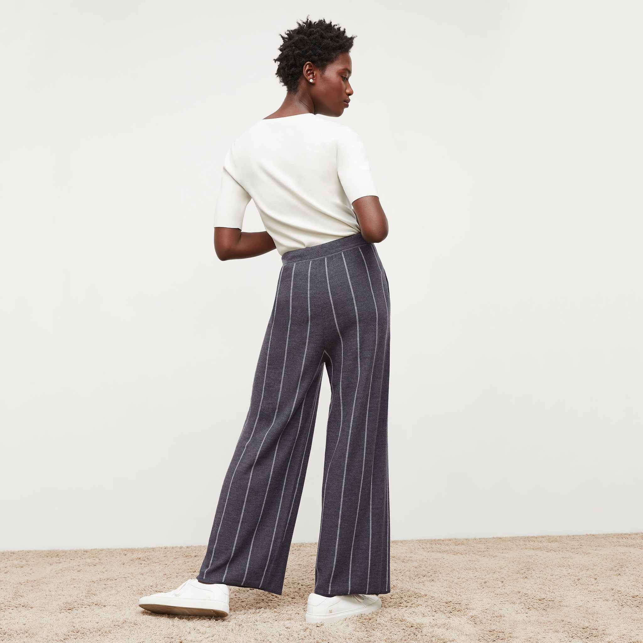 Back image of a woman standing wearing the tressa pant in braided stripe in charcoal and ivory