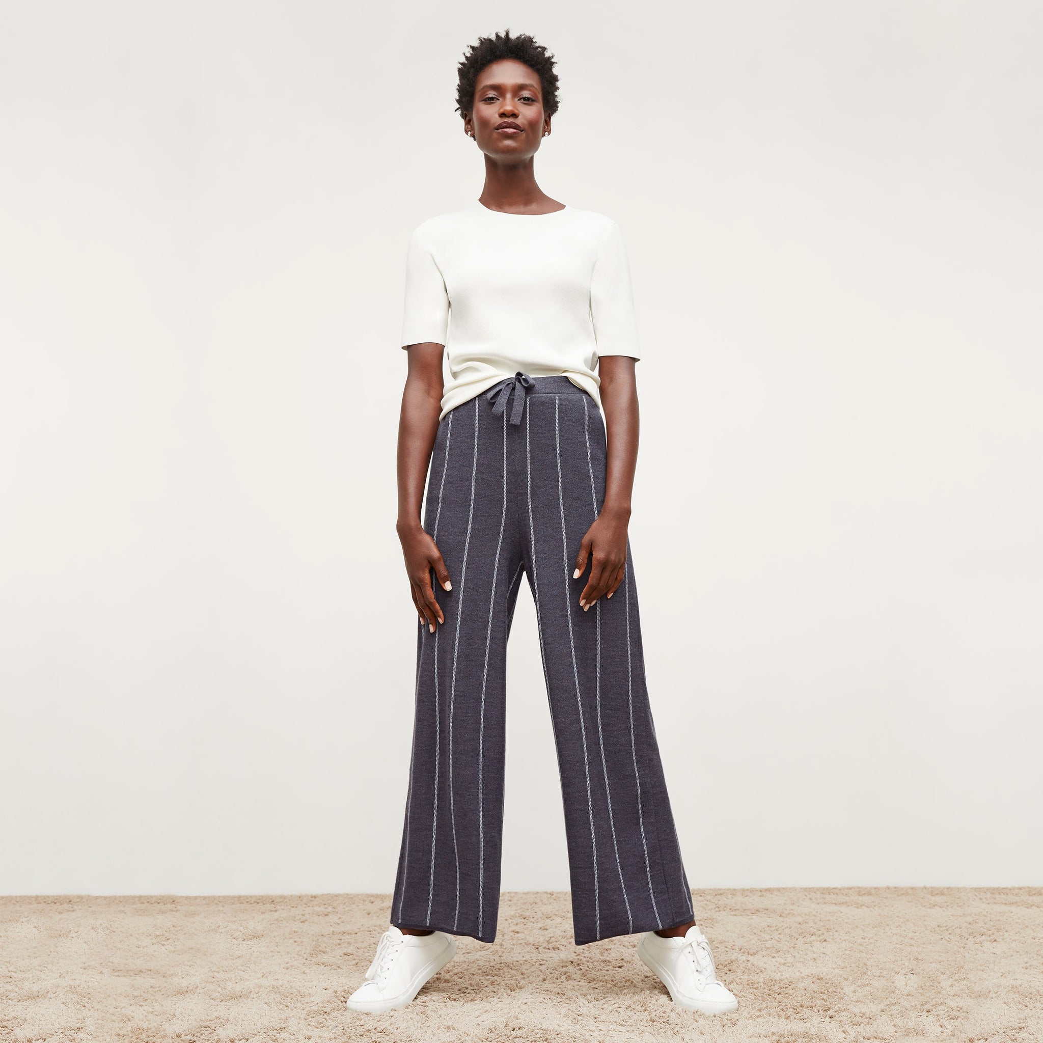 Front image of a woman standing wearing the tressa pant in braided stripe in charcoal and ivory