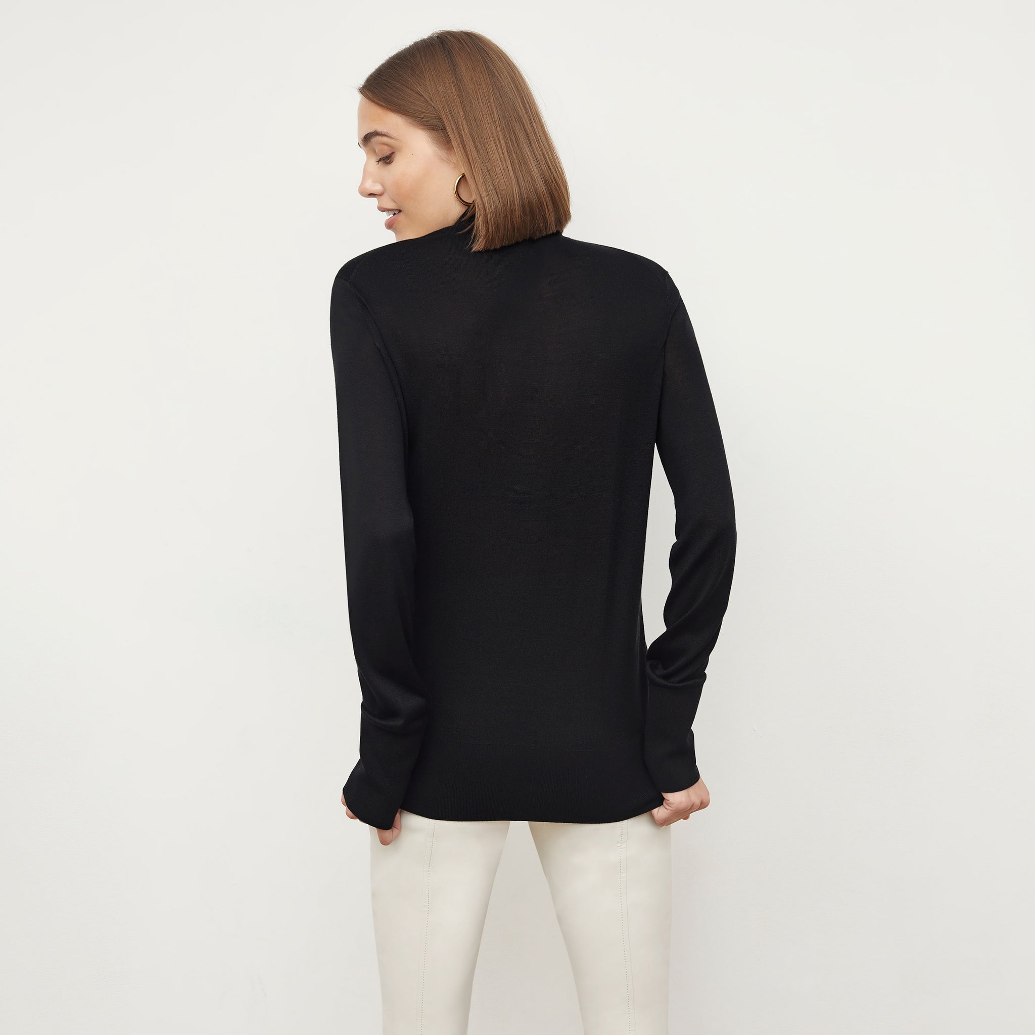 Front image of a woman wearing the elizabeth top in black