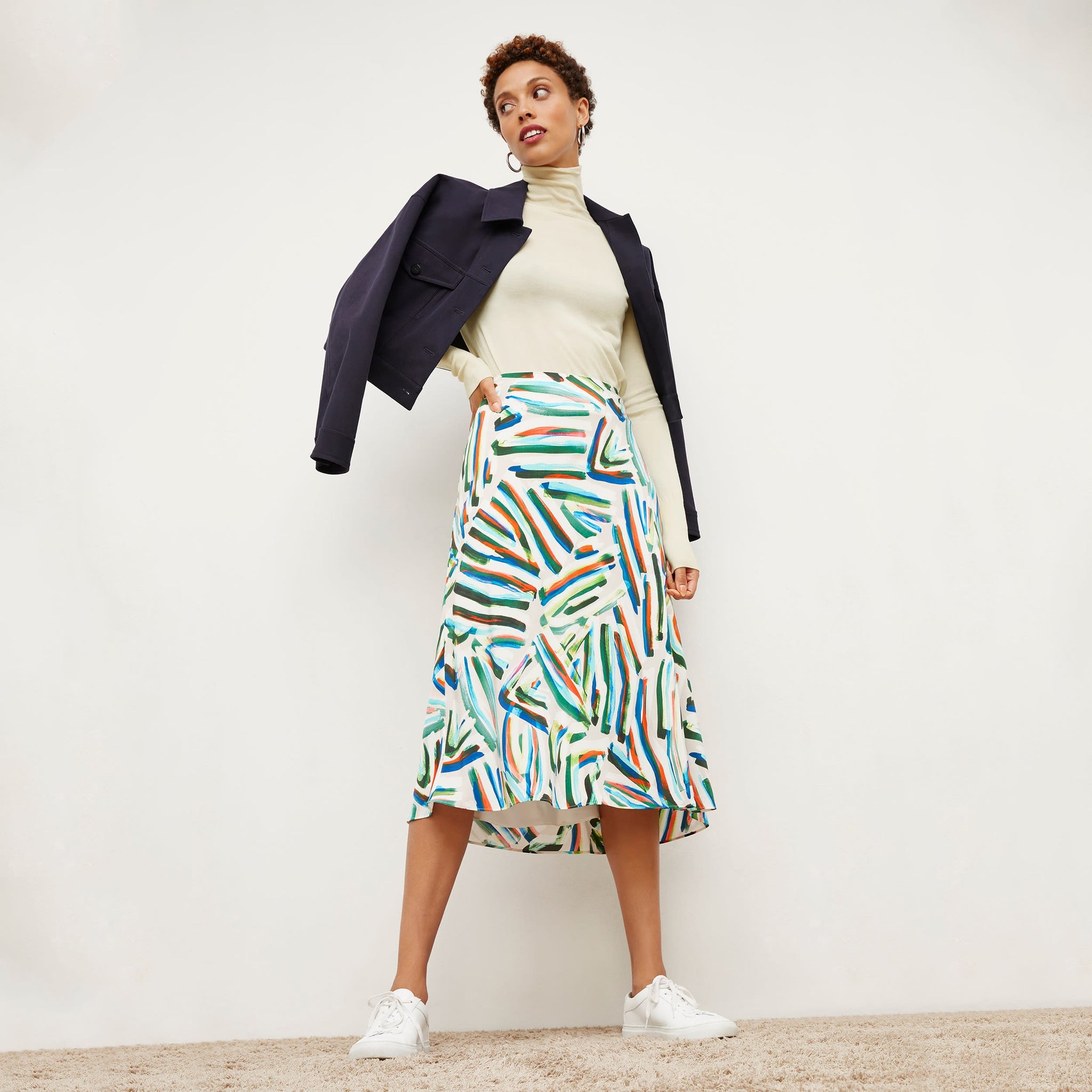 Front image of a woman wearing the orchard skirt in city lights print