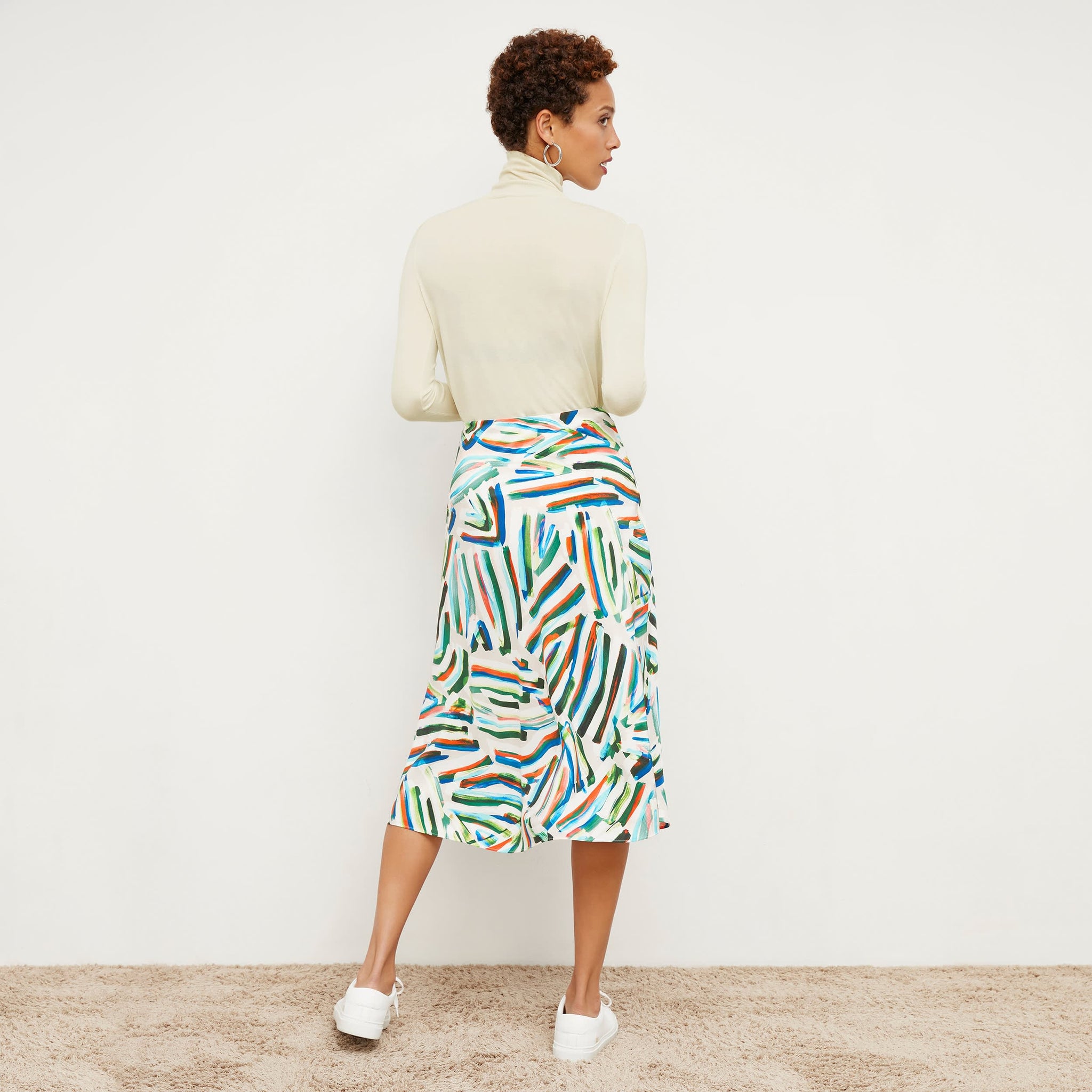 Back image of a woman wearing the orchard skirt in city lights print