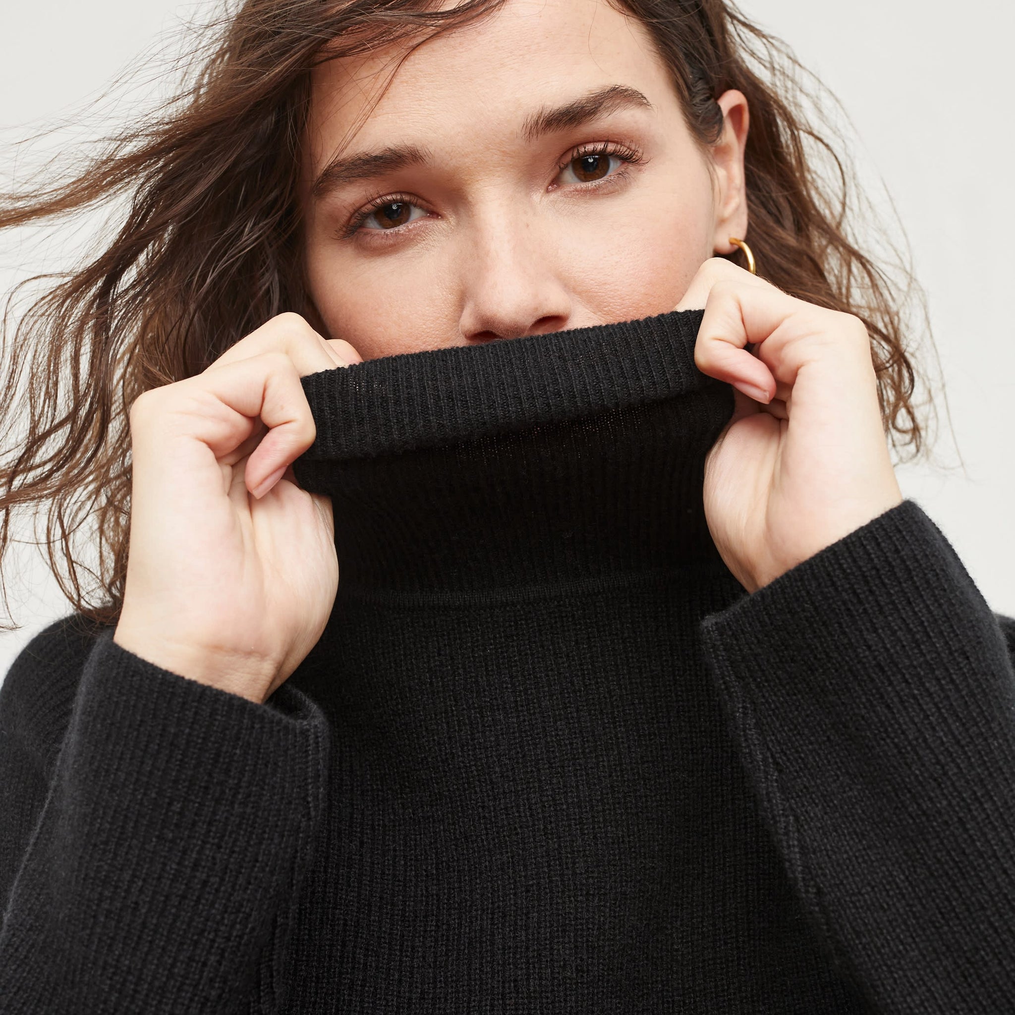 Detail image of a woman standing wearing the Arbus Sweater in Black