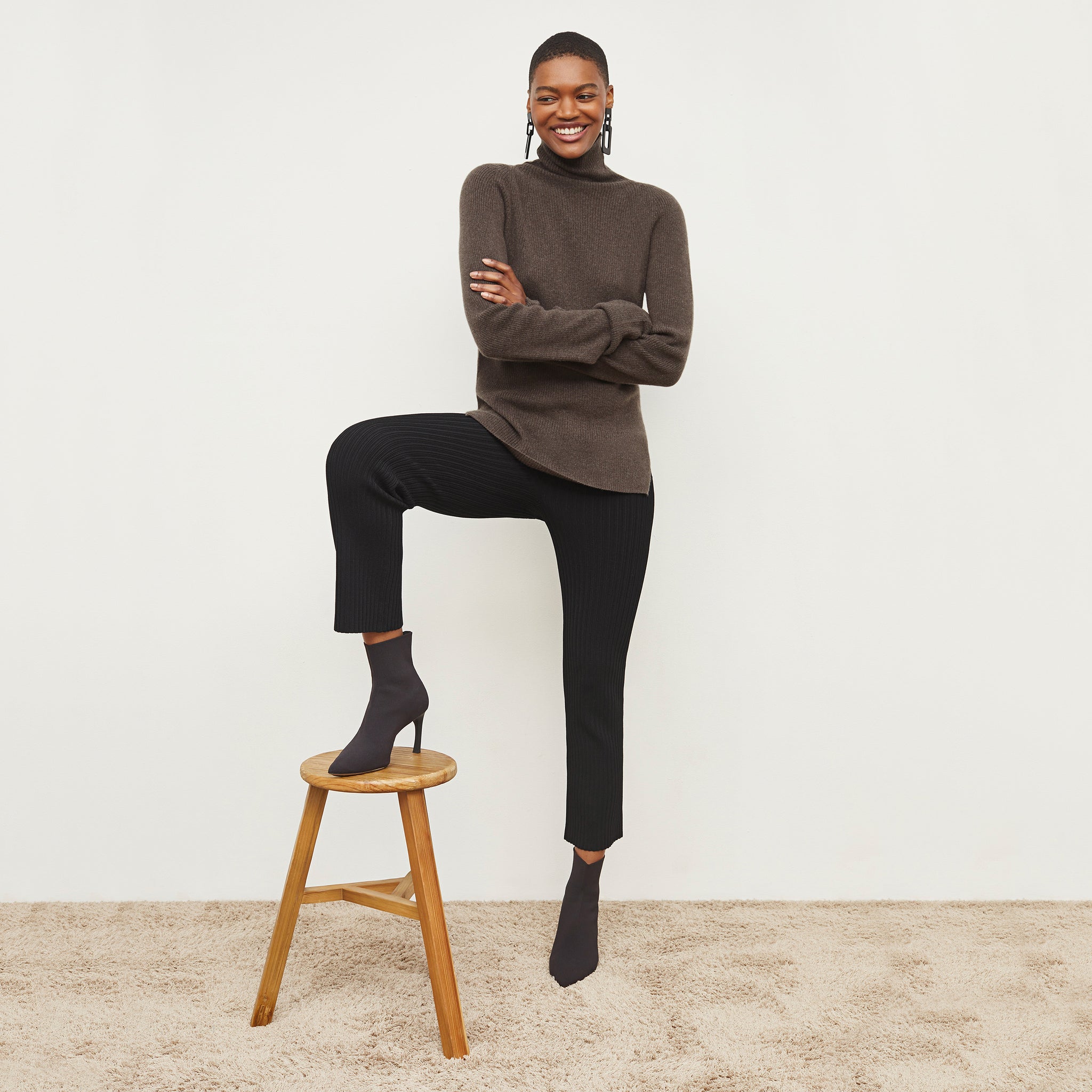 Front image of a woman standing wearing the Finley Legging—Ribbed Jardigan Knit in Black