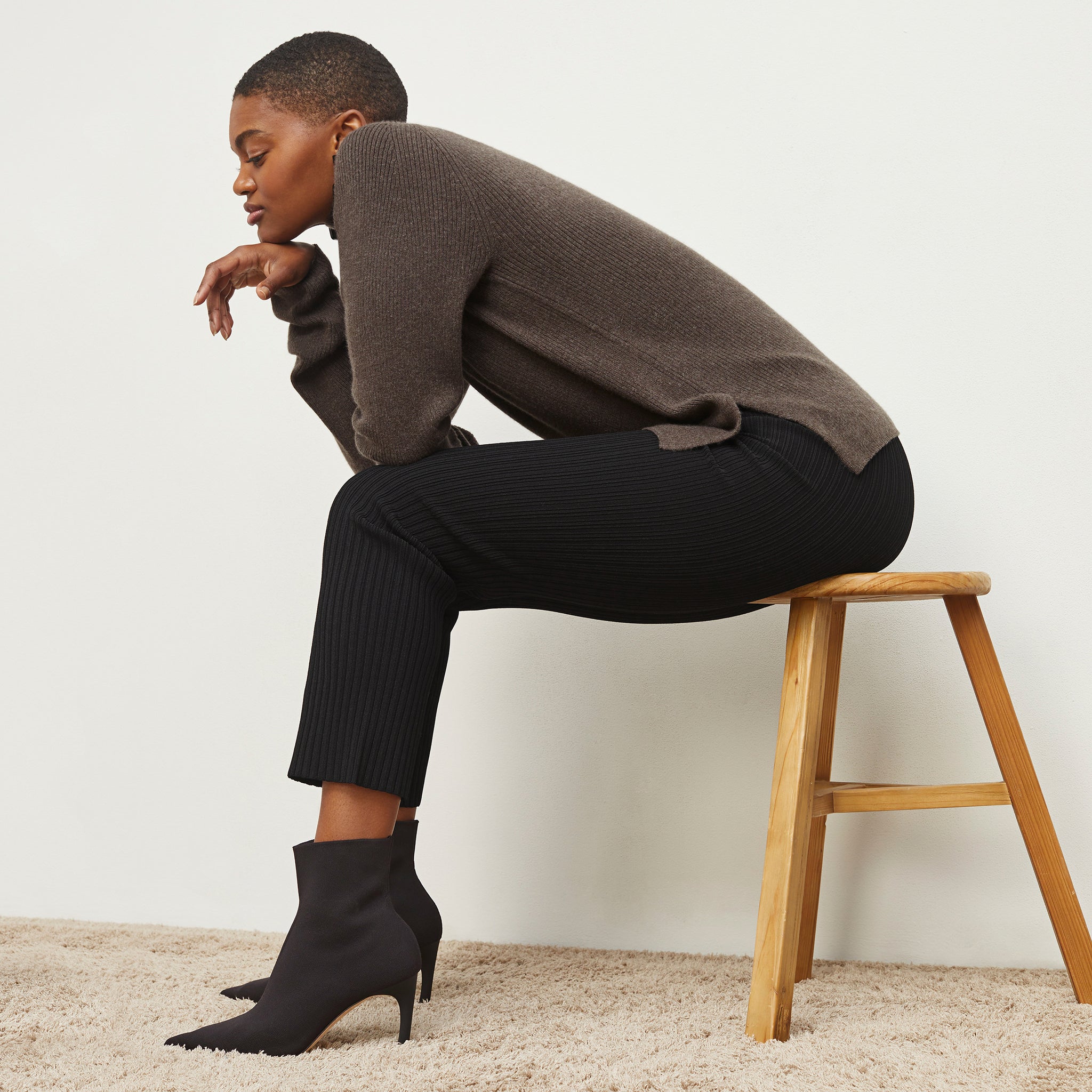 Front image of a woman standing wearing the Finley Legging—Ribbed Jardigan Knit in Black