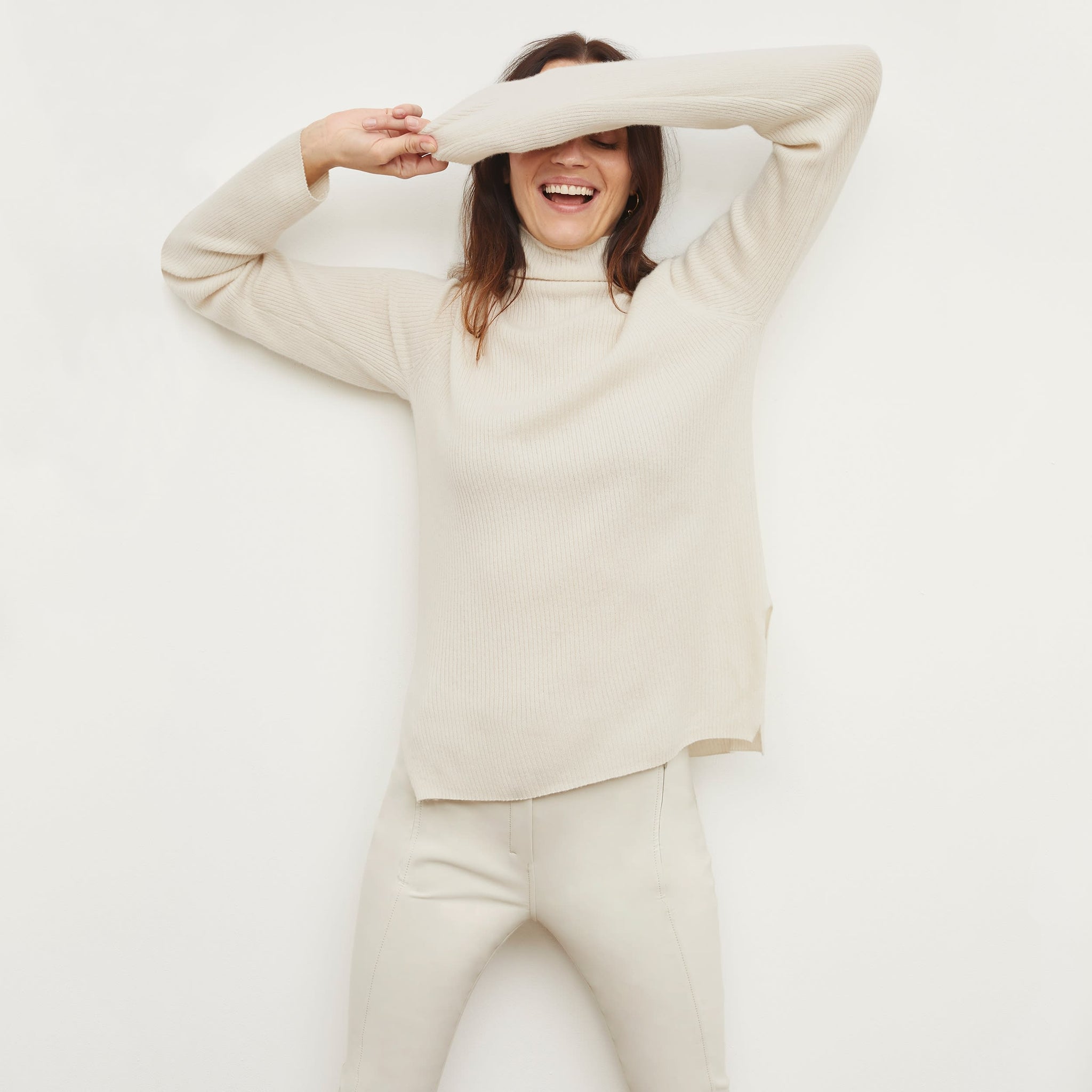 front image of a woman wearing the mckenzie sweater in light cream