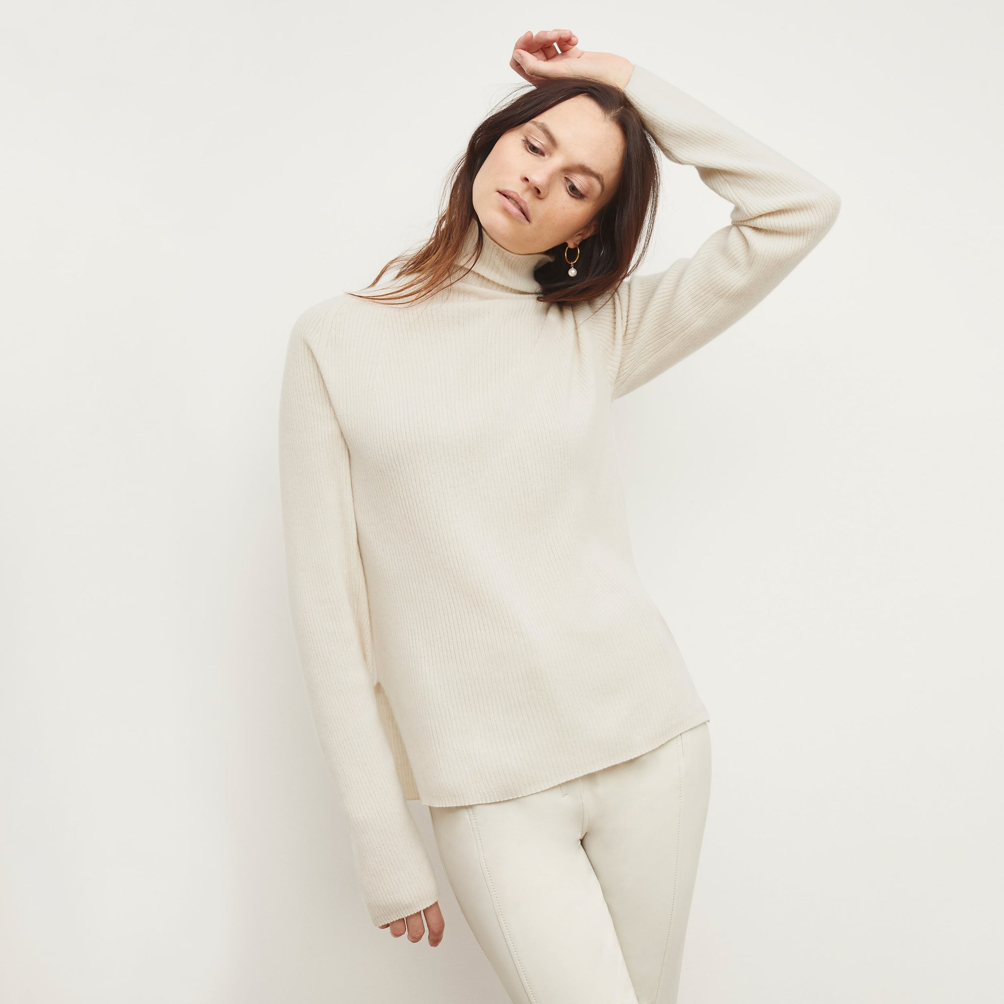 front image of a woman wearing the mckenzie sweater in light cream 