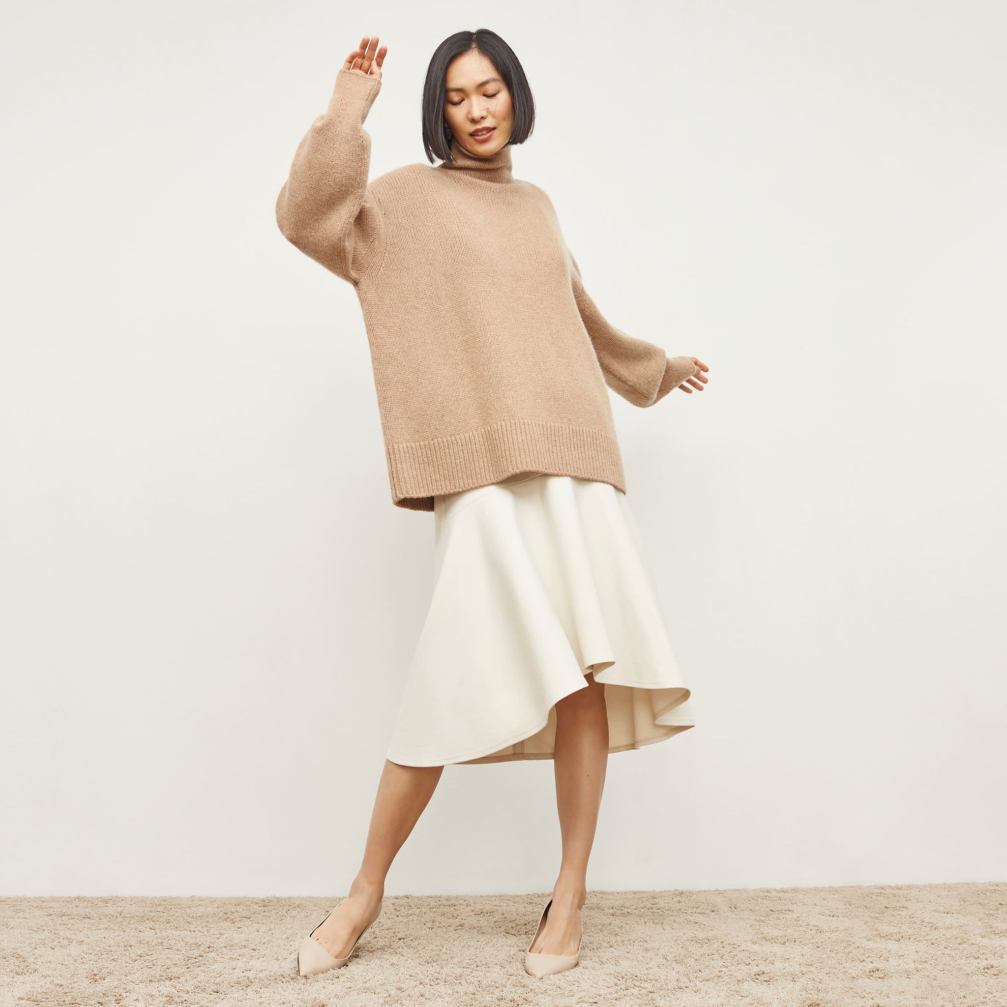 Side image of a woman standing wearing the james dress in pearl