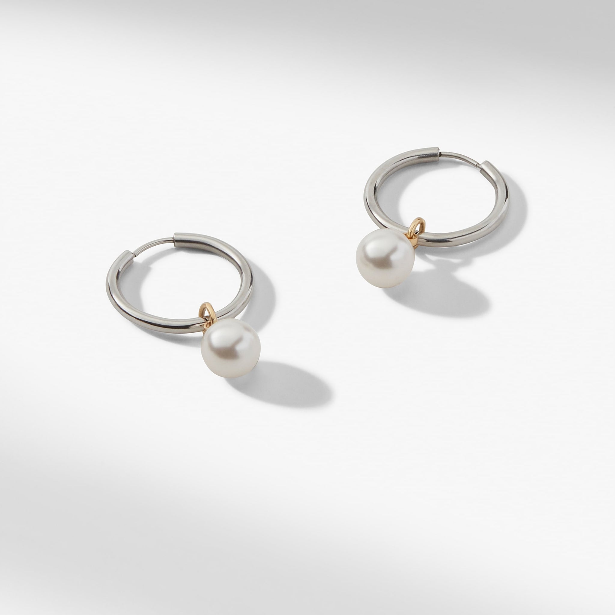 still image of the Claude Charms in Gold on the claressa hoop small in silver