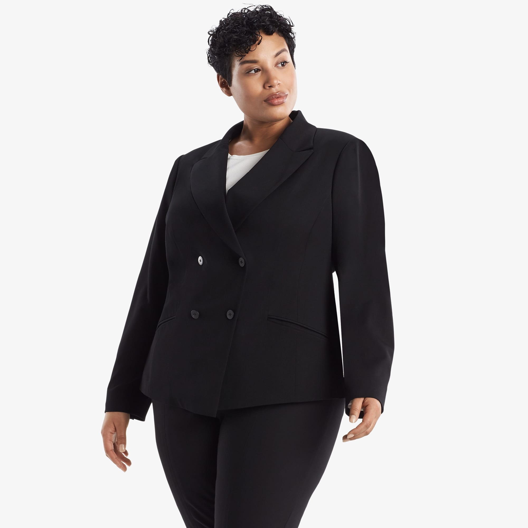 Side image of a woman standing wearing the Roxane Jacket in black
