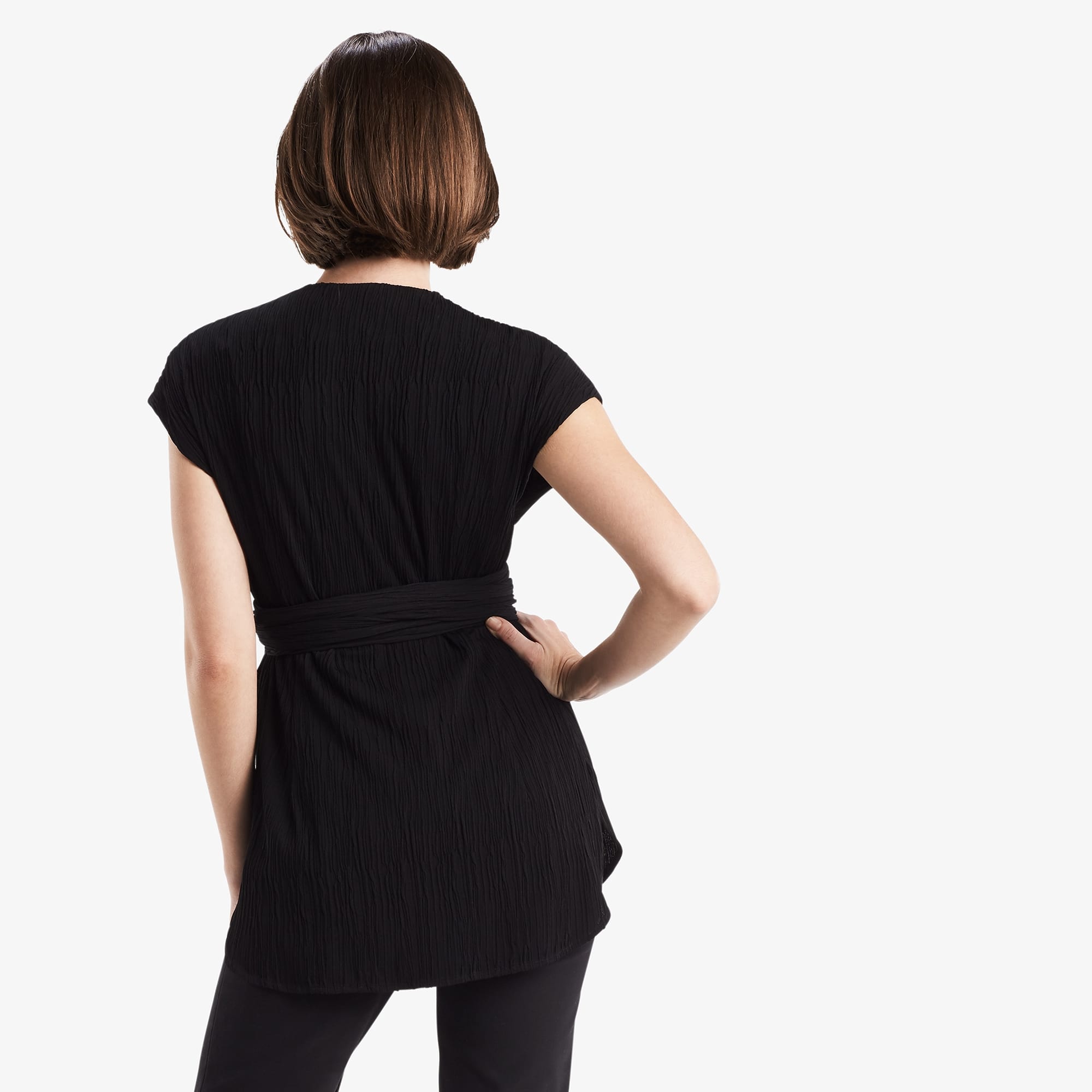 Back image of a woman standing wearing the Valerie Top in black